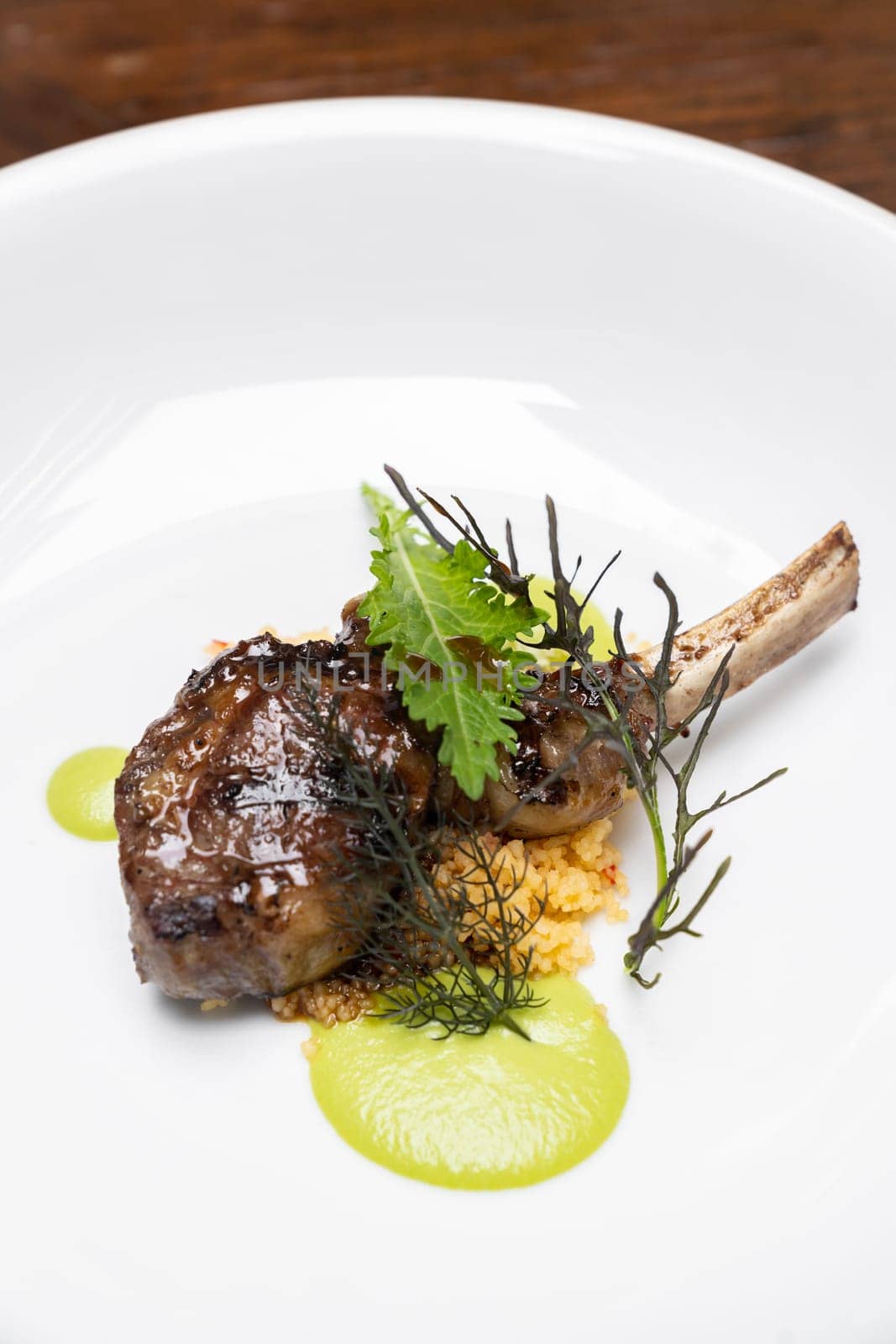 Grilled lamb chop with pesto sauce, international gourmet cuisine a la carte in buffet live station. Using for food and drink industry.