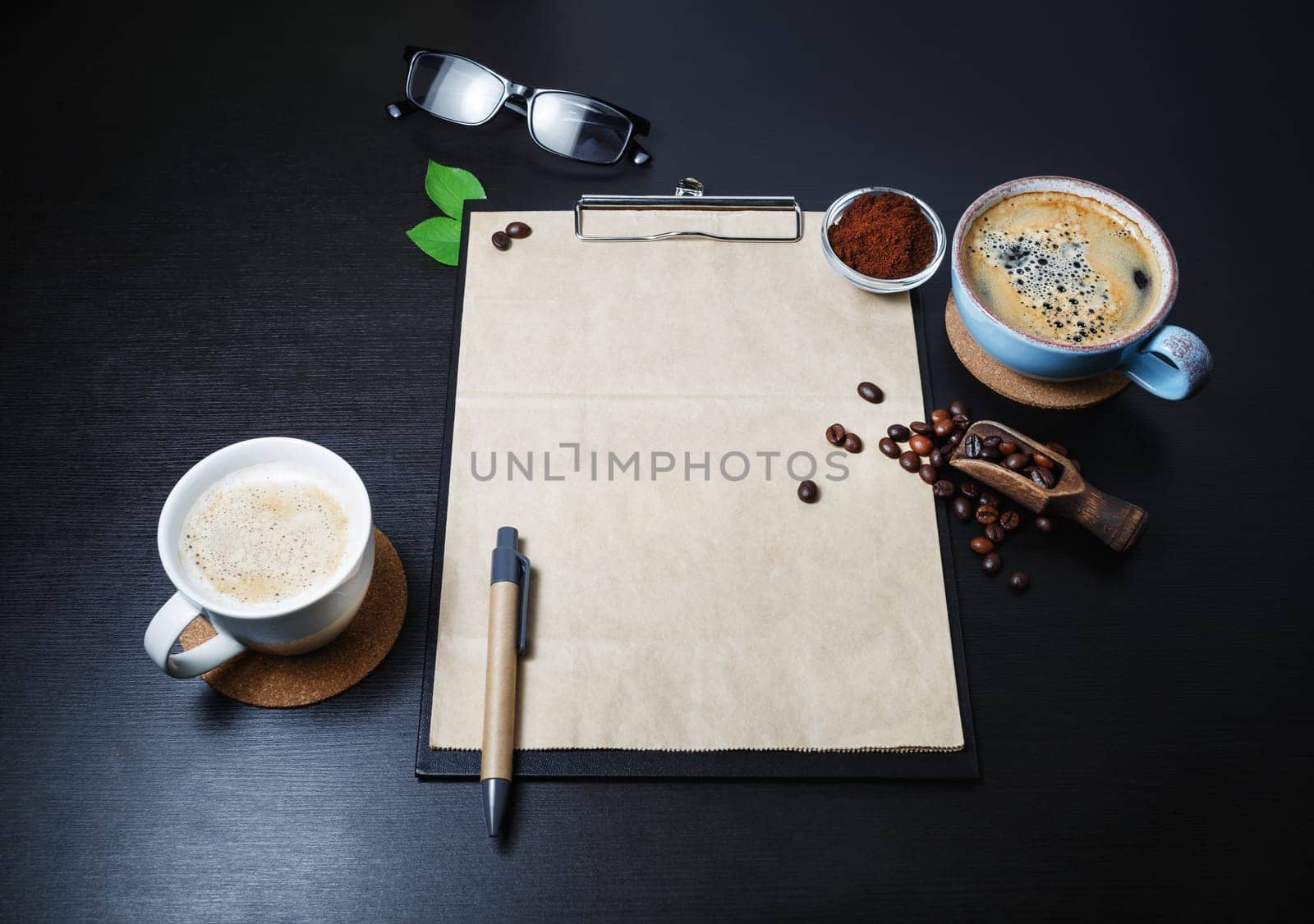 Blank retro stationery and coffee cups on black kitchen table background. Branding mock up.