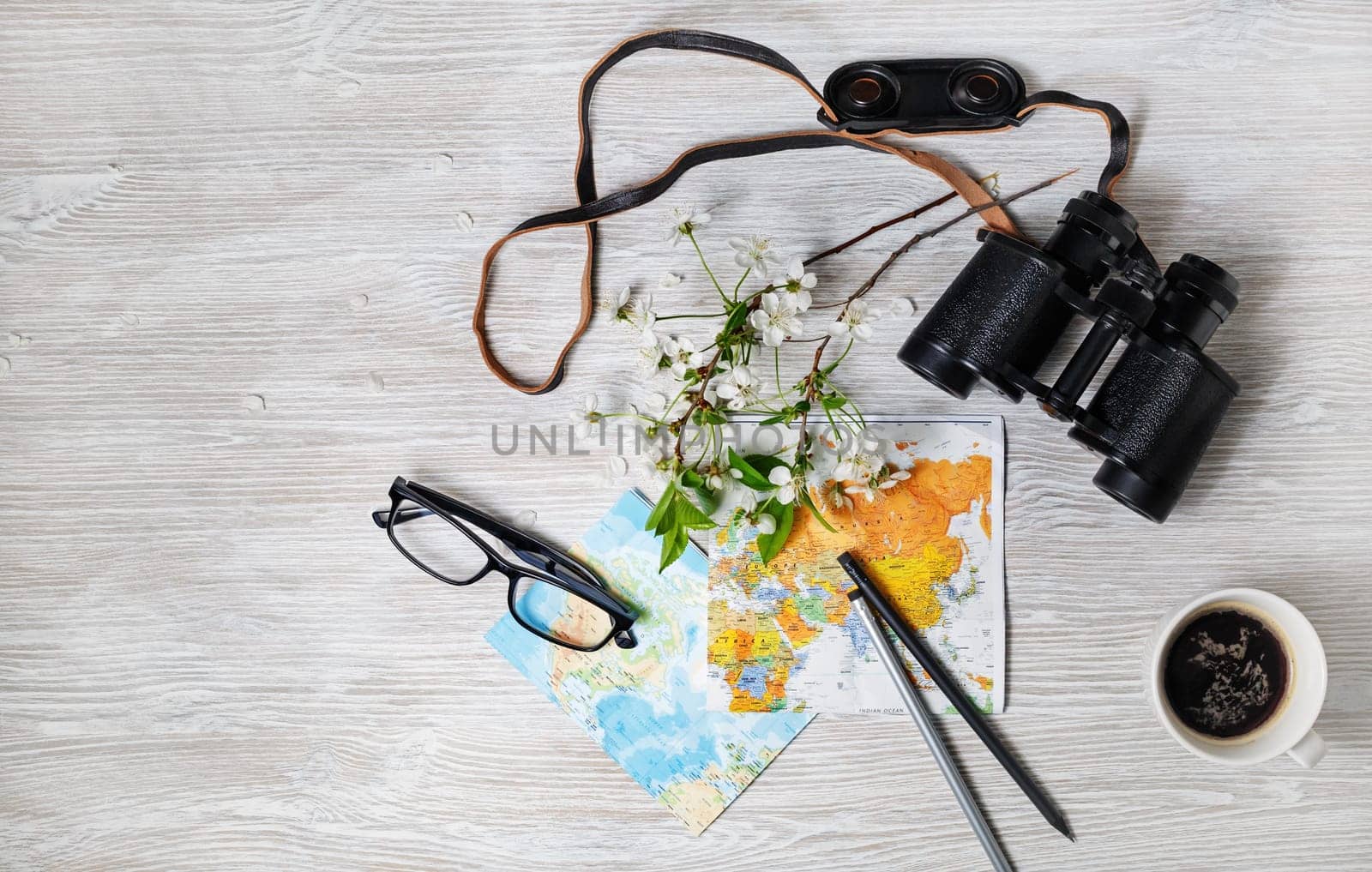 Objects for tourism and travel on light wooden background. Trip or vacation items. Top view. Flat lay.