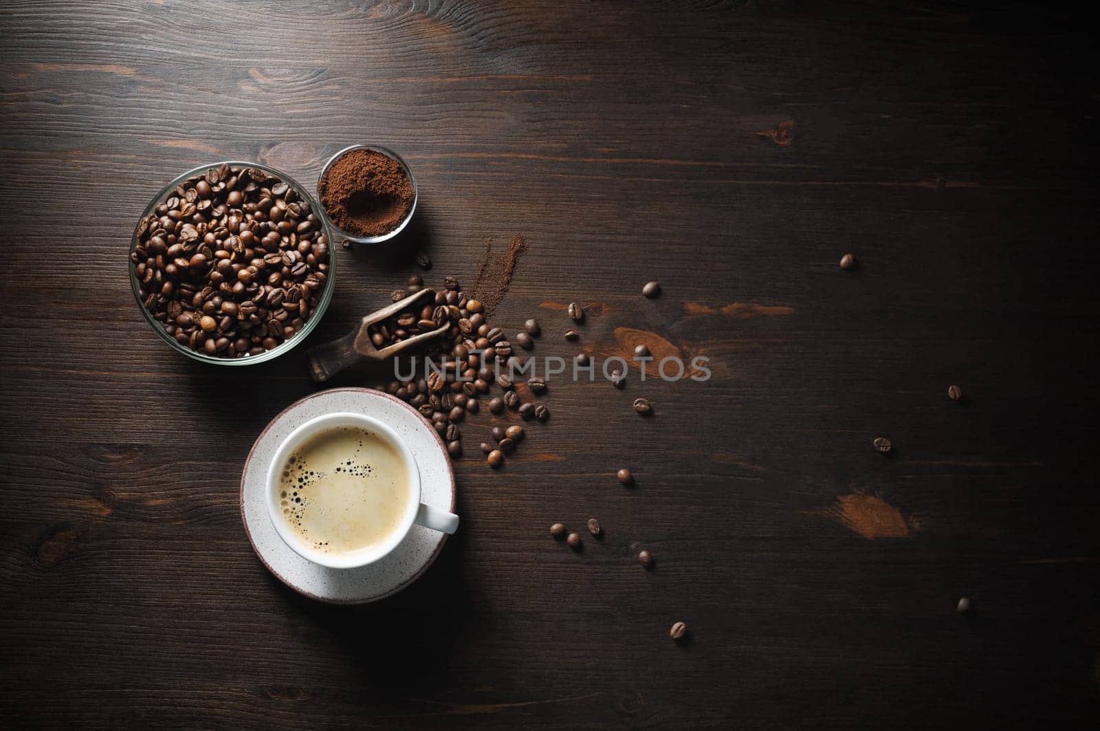 Coffee cup, roasted coffee beans and ground powder on old wooden kitchen table background. Top view. Flat lay.