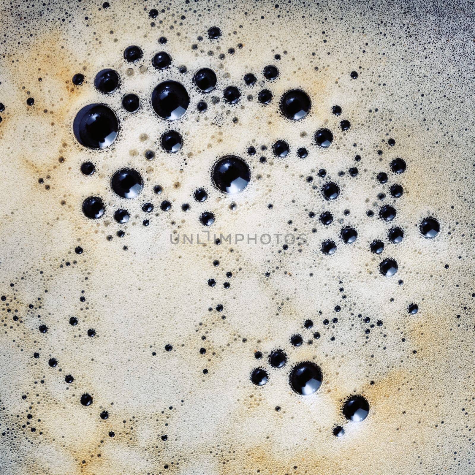 Close-up coffee foam with bubbles. Top view. Flat lay.