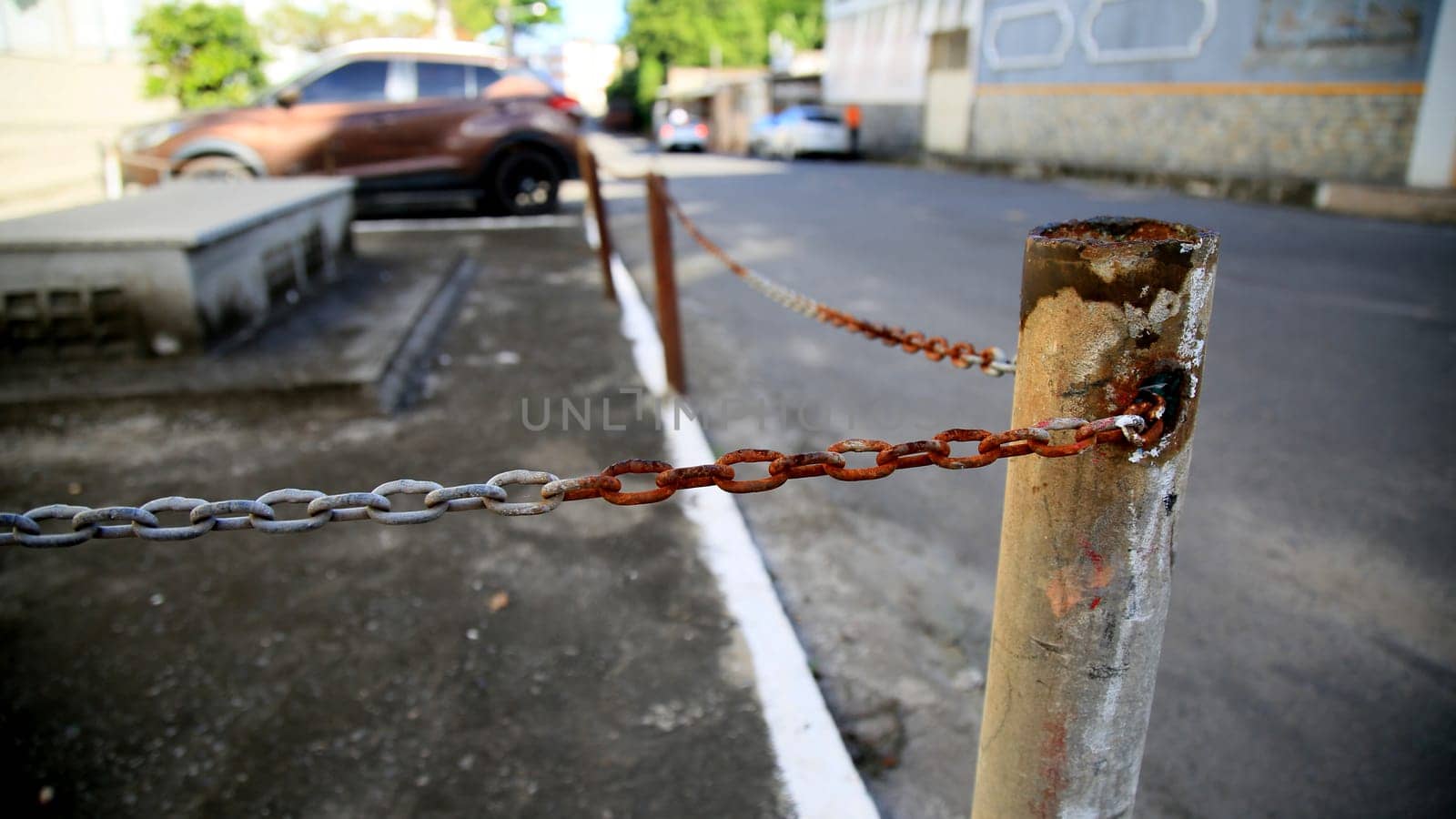 salvador, bahia / brazil - july 4, 2020: rusty chain is seen on the street in the neighborhood of Cabula in the city of Salvador...