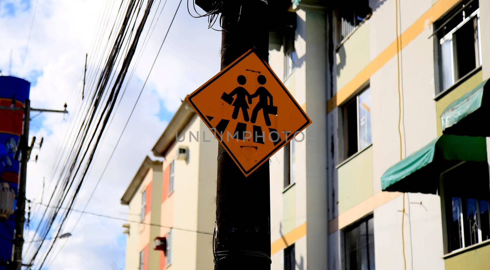 salvador, bahia / brazil - july 4, 2020: traffic signs indicate pedestrian crossing, seen on a pole connected to the electricity grid in the Cabula neighborhood, in the city of Salvador....