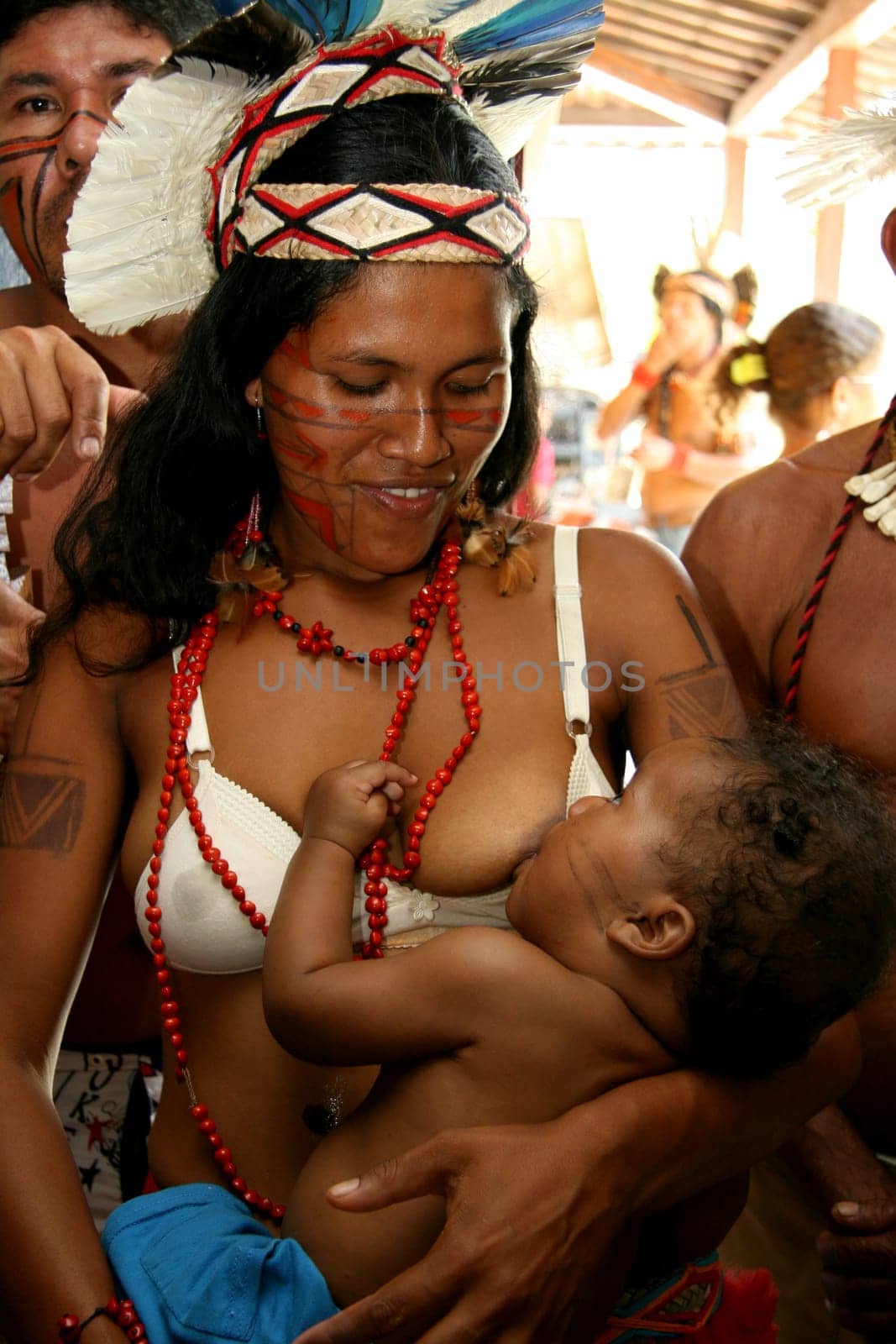 porto seguro, bahia / brazil - february 27, 2008: pataxo indian woman breastfeeds her son during a protest in search of improvements in the health system of her village in the city of Porto Seguro