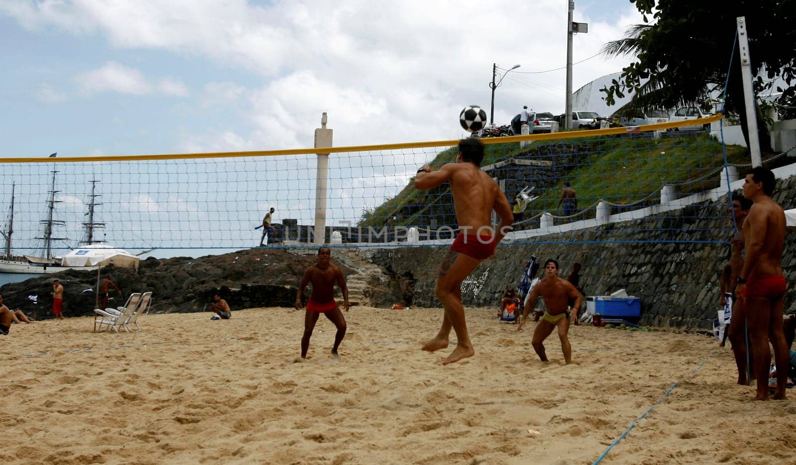 eunapolis, bahia / brazil - october 26, 2014: people are seen watching football on the beach at Porto da Barra in the city of Salvador.