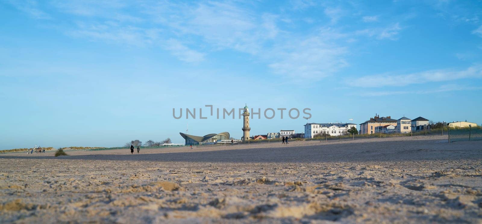 Beach of Warnemünde in Germany with view of the Landmarks Lighthouse and Teepott