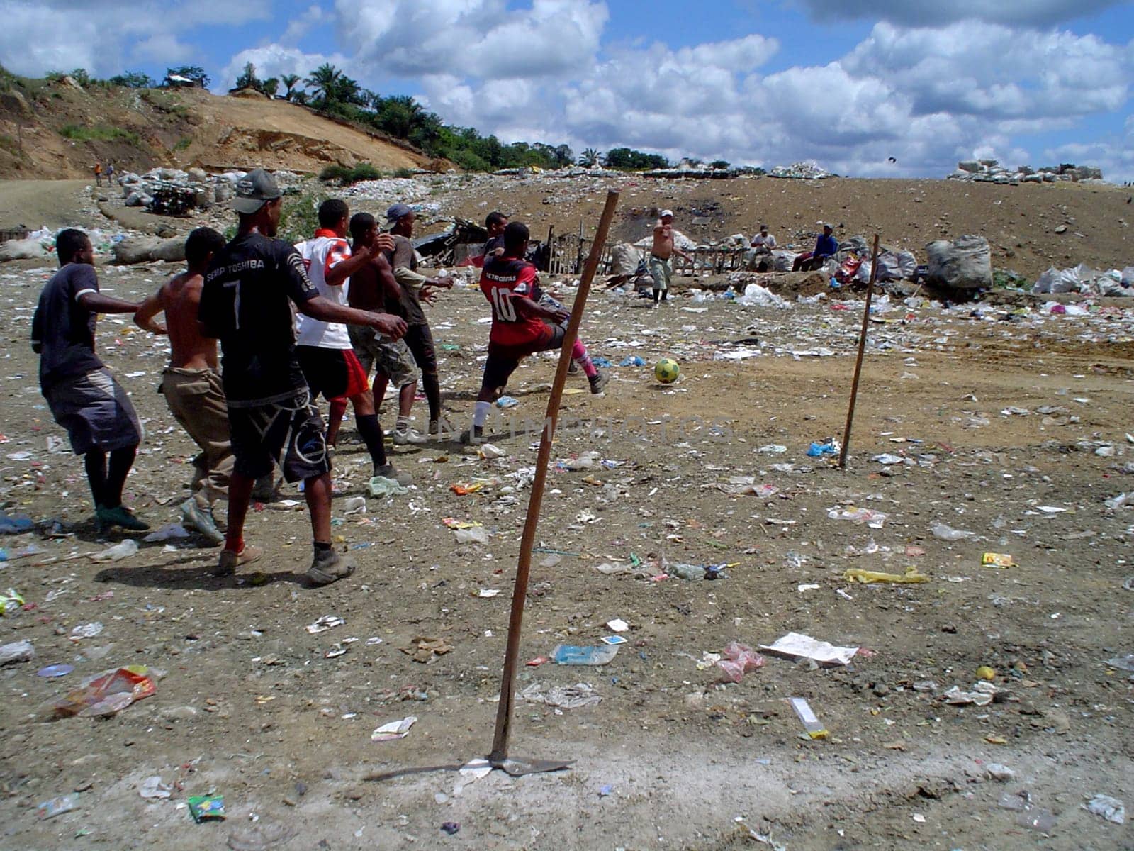 itabuna, bahia / brazil - september 22, 2011: waste pickers are seen playing football at the landfill in the city of itabuna.
