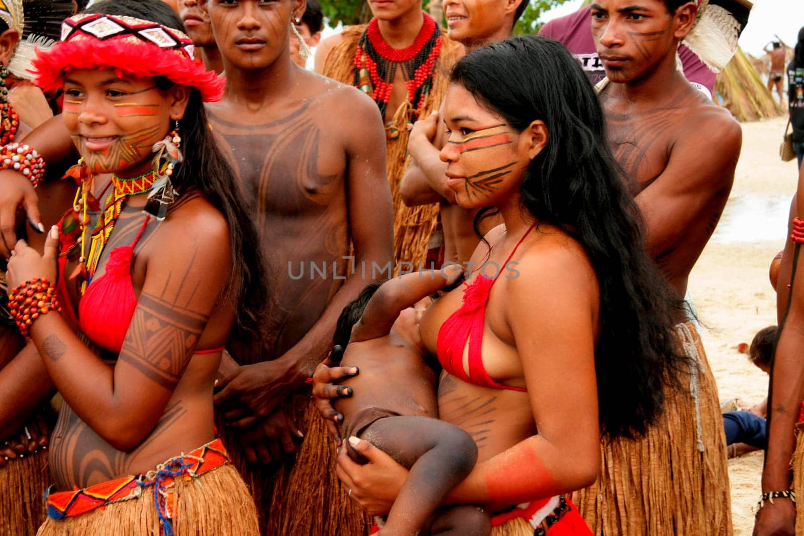 santa cruz cabralia, bahia / brazil - april 19, 2009: pataxo ethina india is seen breastfeeding her child during indigenous games in the Coroa Vermelha village in Santa Cruz Cabralia.