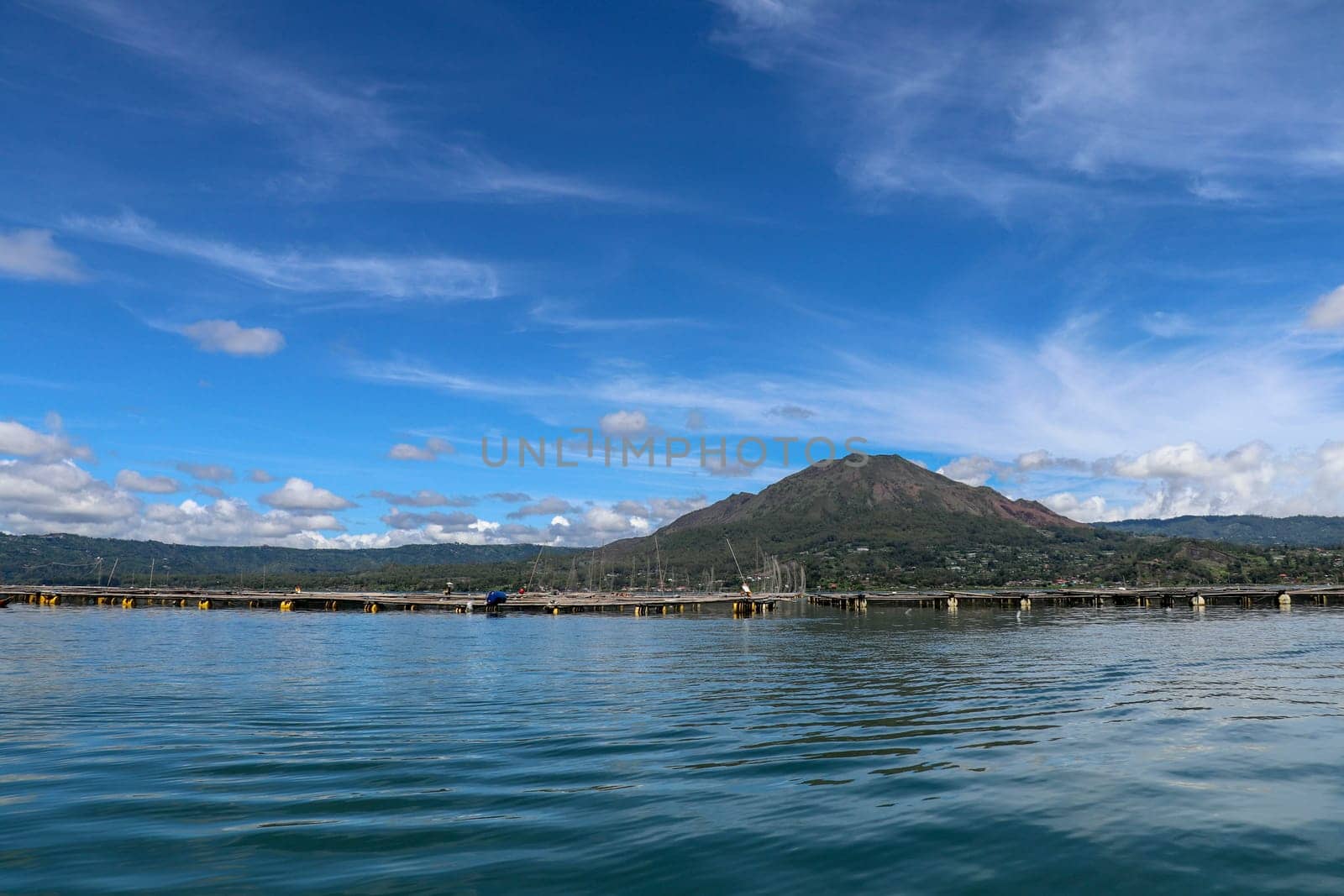 Batur volcano on Bali island, Indonesia. Active Indonesian Volcano Batur in the tropical island. Batur lake and volcano are in the central mountains of Bali near the Kintamani village, Indonesia.