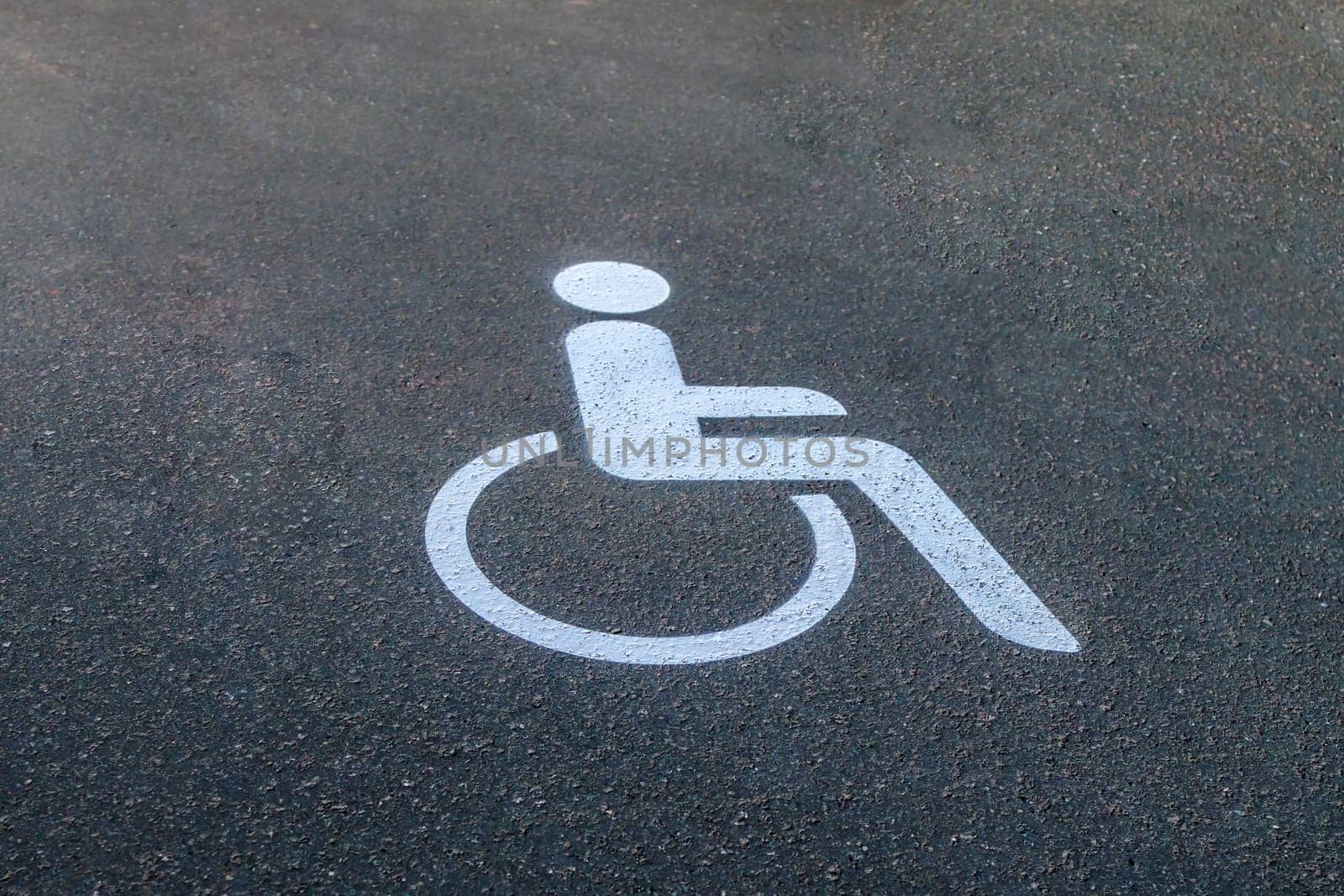 White Road marking for wheelchair users on asphalt