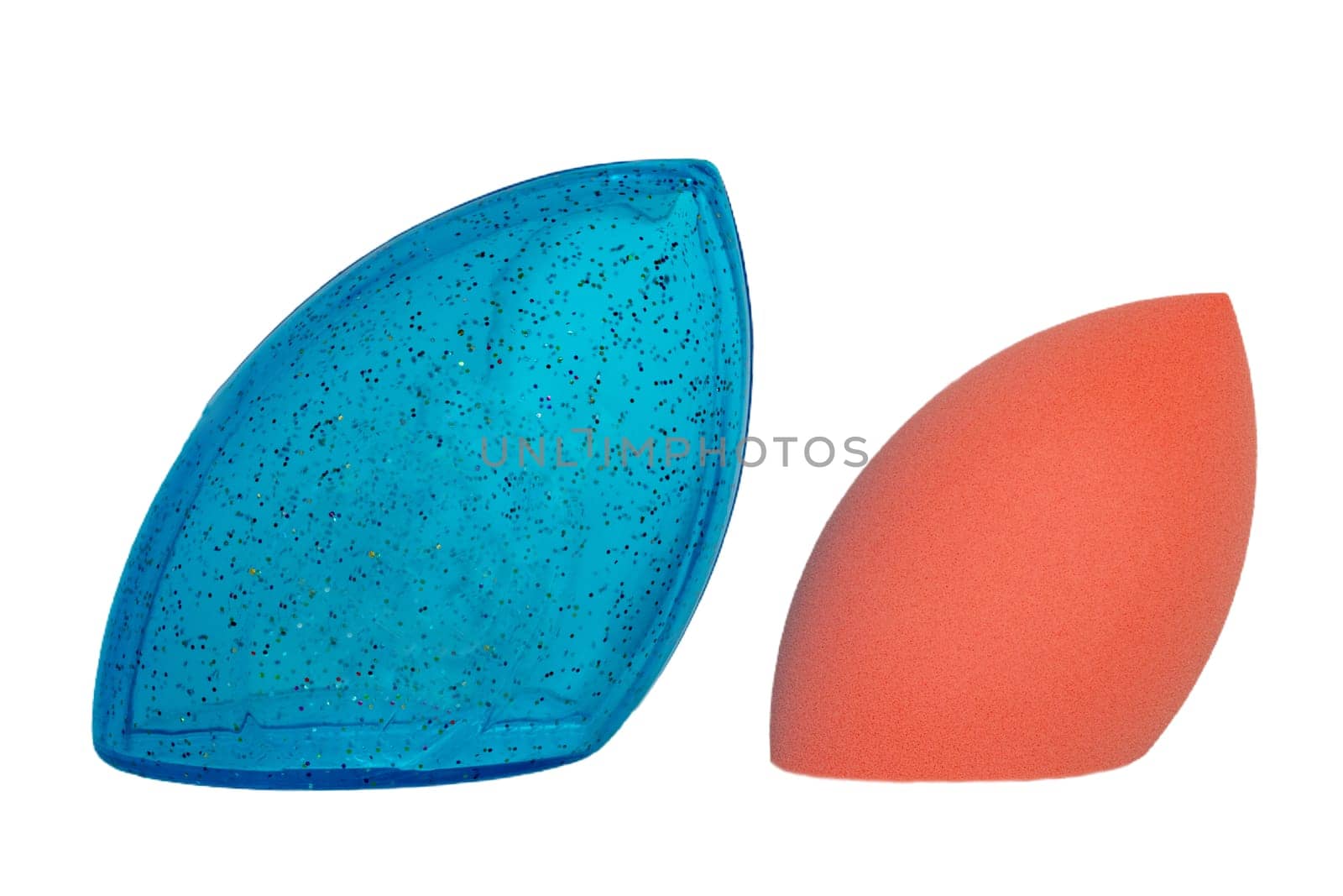 Sponge isolated. Close-up of a pink cosmetic sponge and a blue plastic package for storage isolated on a white background. Beauty concept. Macro photograph.