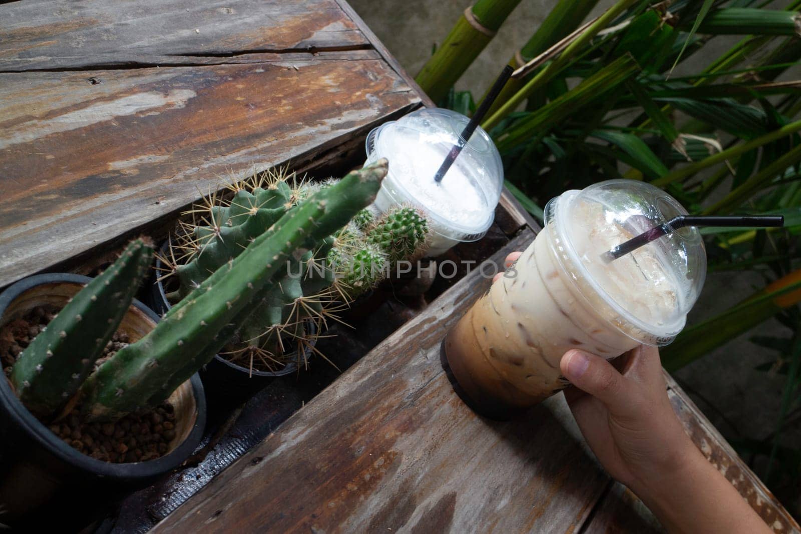 Hand on iced coffee drink, stock photo