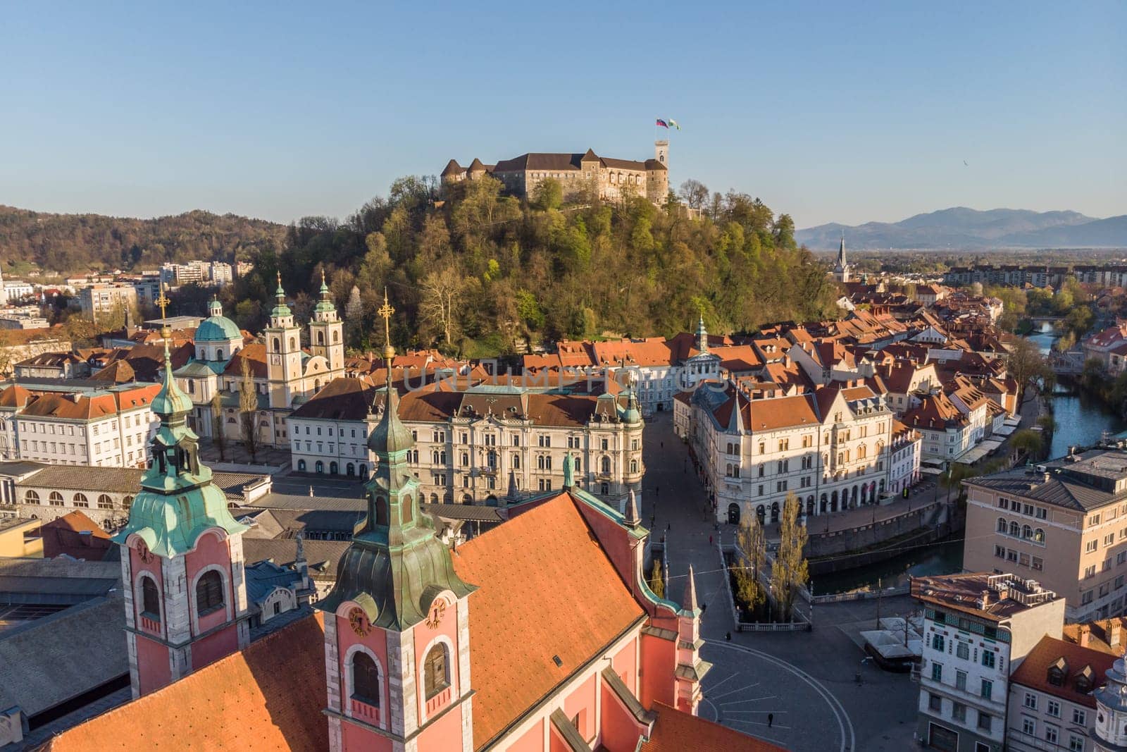 Aerial drone panoramic view of Ljubljana, capital of Slovenia in warm afternoon sun.