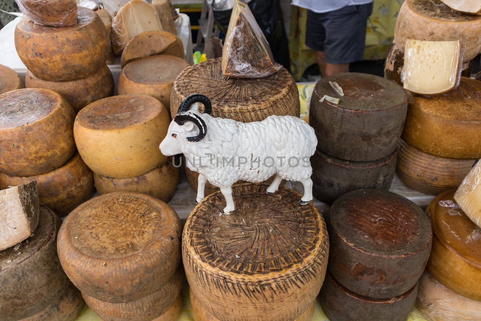 Various traditional Italian cheese on a market stand.