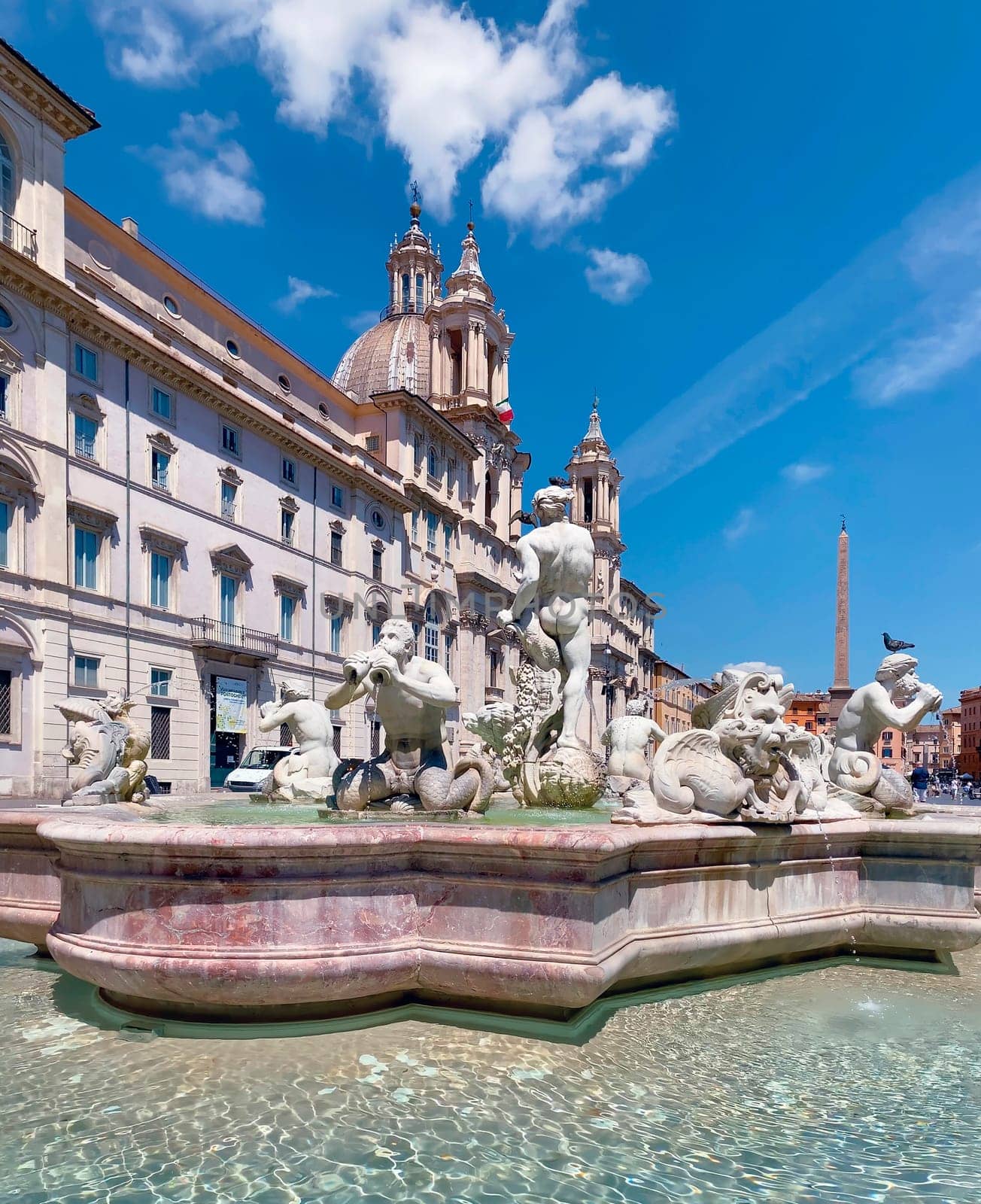 Piazza Navona in Rome on a sunny day. Baroque architecture and marble fountain with statues. Town square. Travel to European capitals