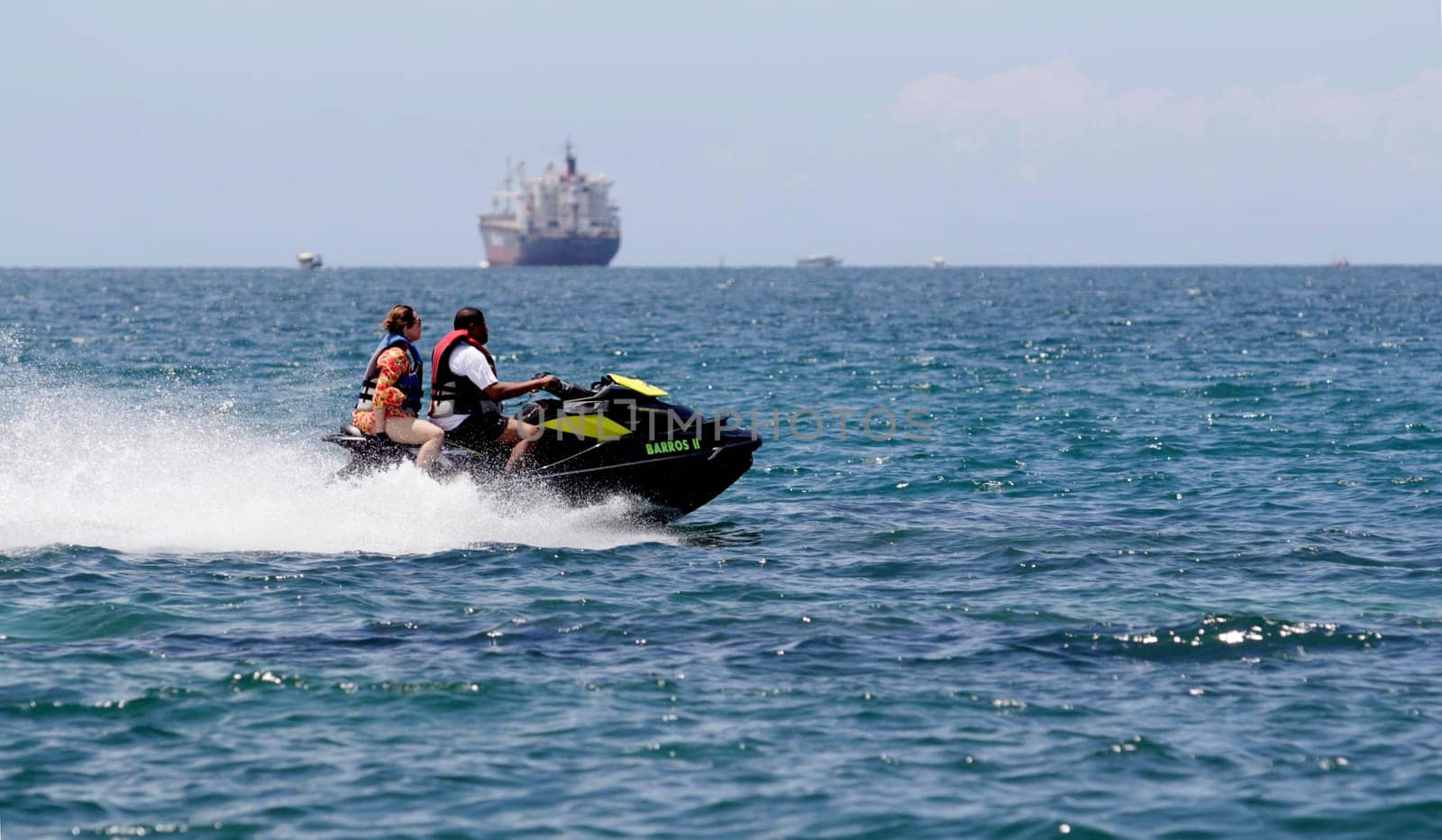 salvador, bahia / brazil - january 1, 2015: watercraft - jet sky - is seen sailing together with bathers on Boa Viagem beach in the city of Salvador.