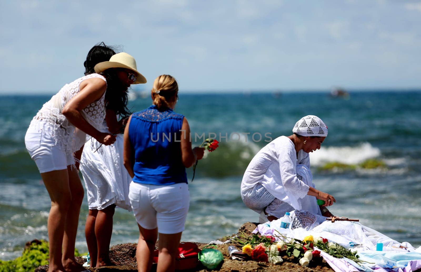 salvador, bahia / brazil - february 2, 2015: supporters of candomble are seen on the Rio Vermelho beach in the city of Salvador during a party in honor of Yemanja.