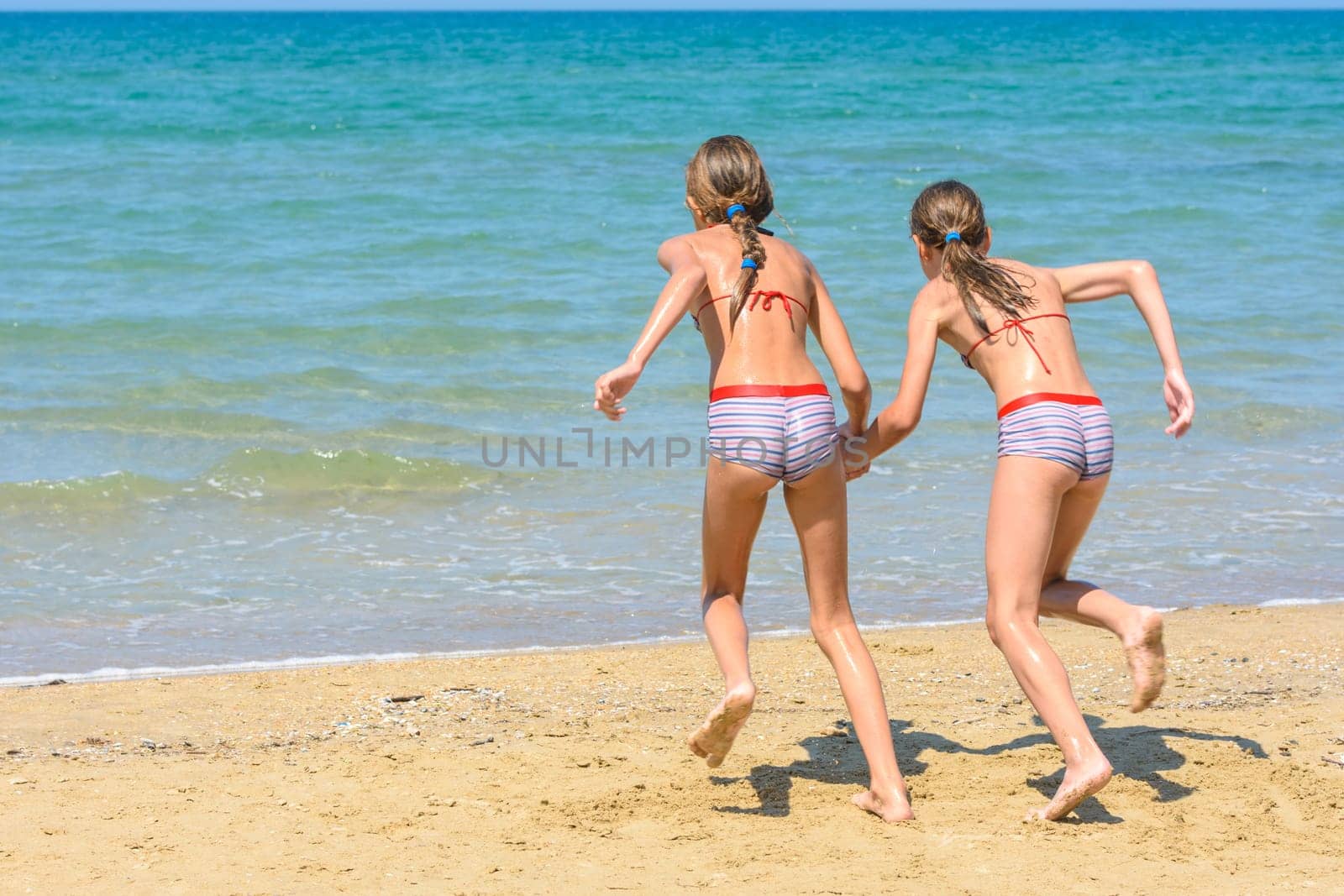Children with a run run swimming in the sea