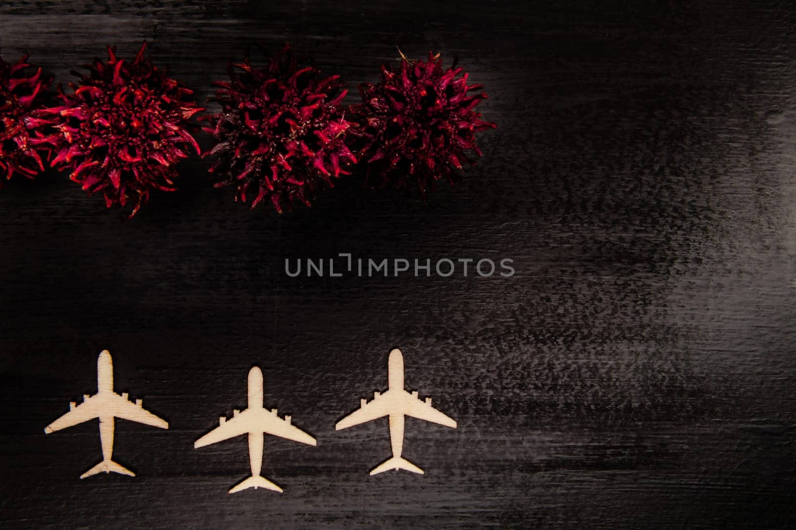 Line of grounded toy planes with COVID-19 virus shapes in front of them, pandemic and economic crisis concept