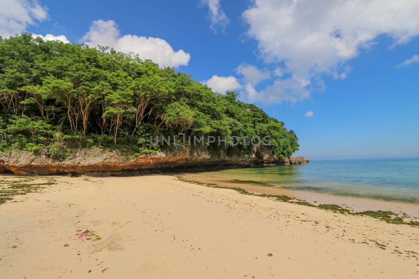 A beautiful view of Padang Padang Beach in Bali, Indonesia. Yellow fine sand.