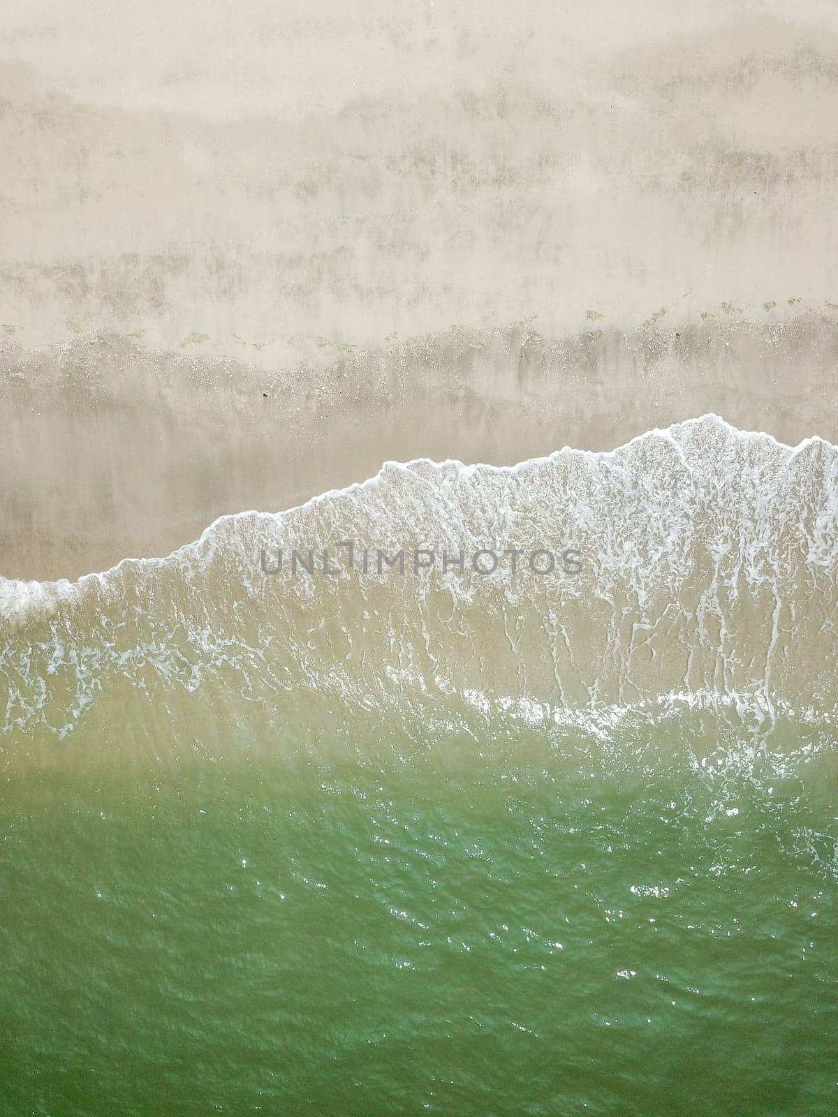 Blue ocean wave on clean sandy beach. Holidays and Travel Concept