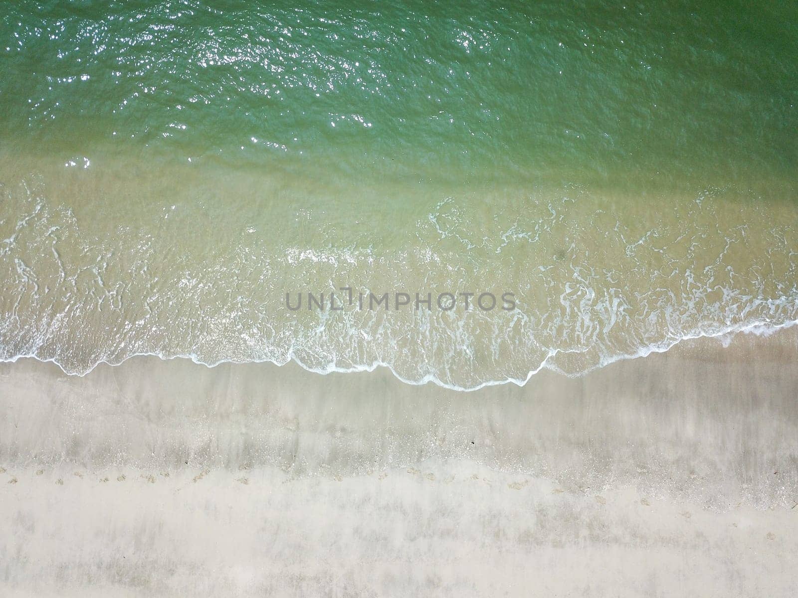 Blue ocean wave on clean sandy beach. Holidays and Travel Concept