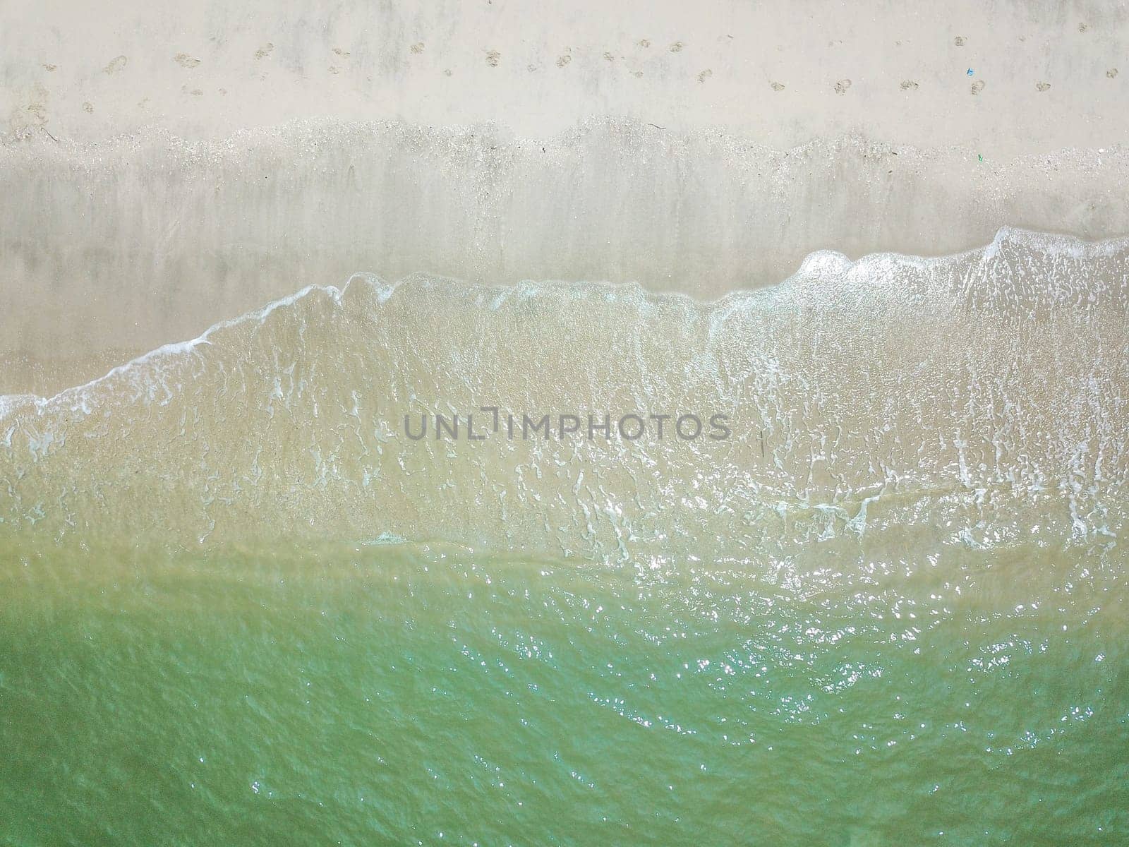 Blue ocean wave on clean sandy beach. Holidays and Travel Concept