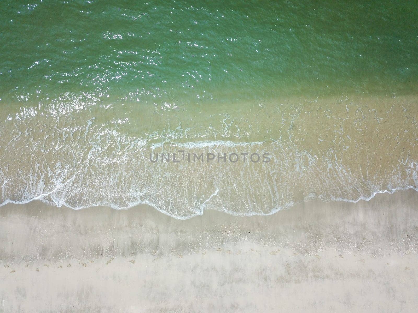 Blue ocean wave on clean sandy beach. Holidays and Travel Concept