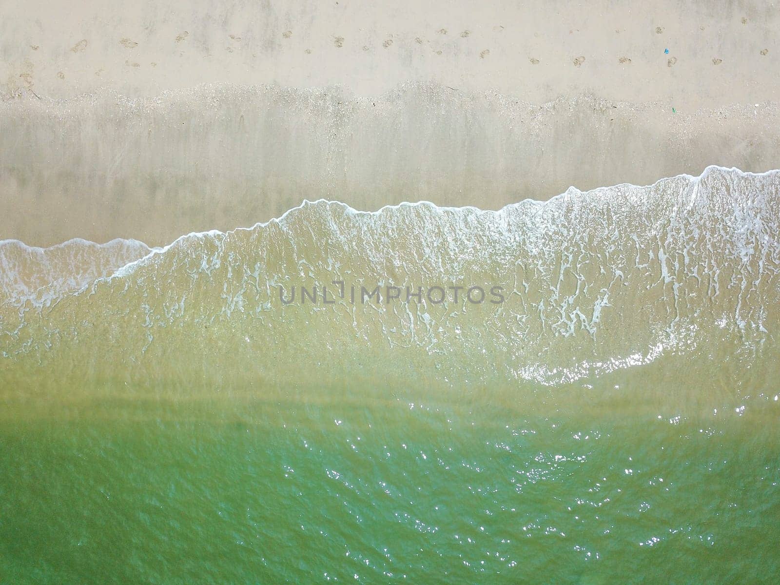 Blue ocean wave on clean sandy beach. Holidays and Travel Concept