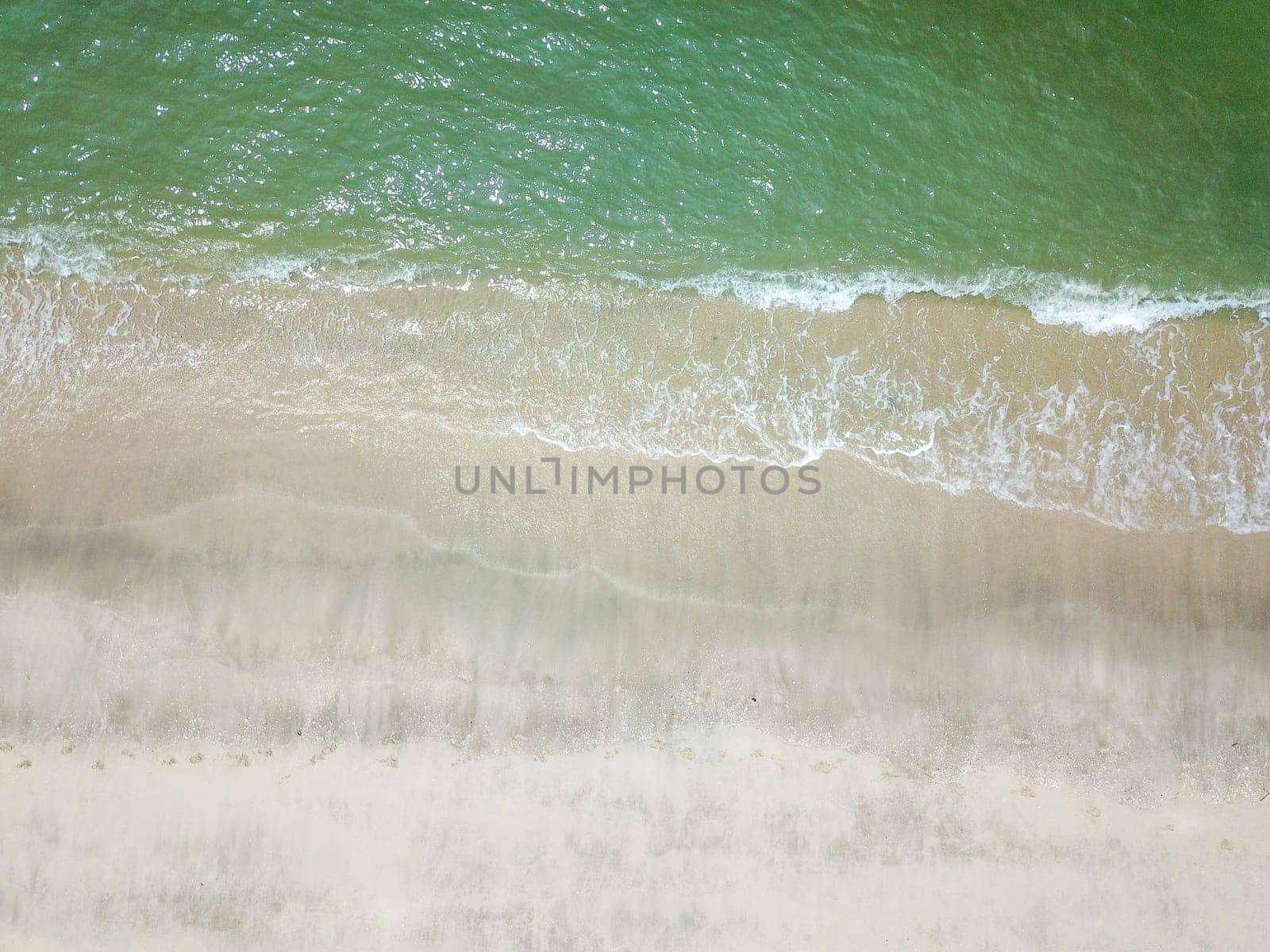 Blue ocean wave on clean sandy beach. Holidays and Travel Concept