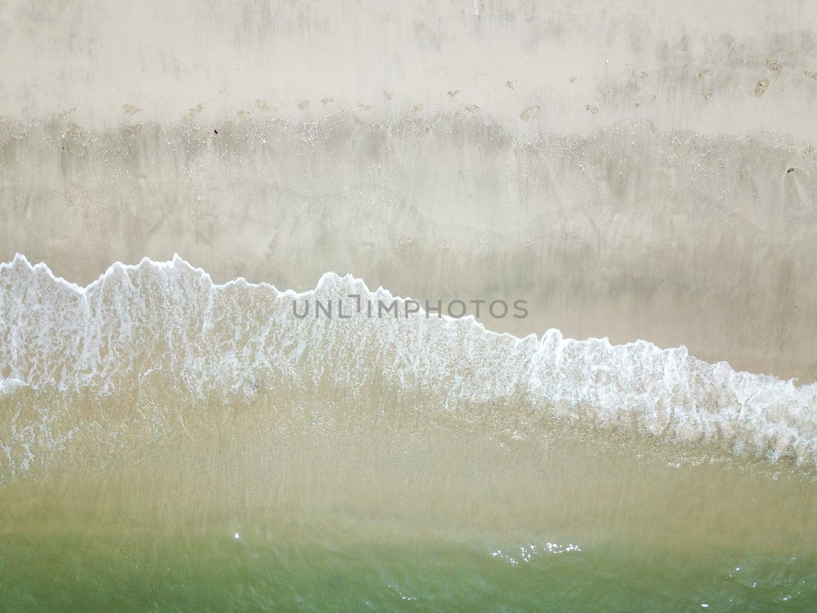 Blue ocean wave on clean sandy beach. Holidays and Travel Concept