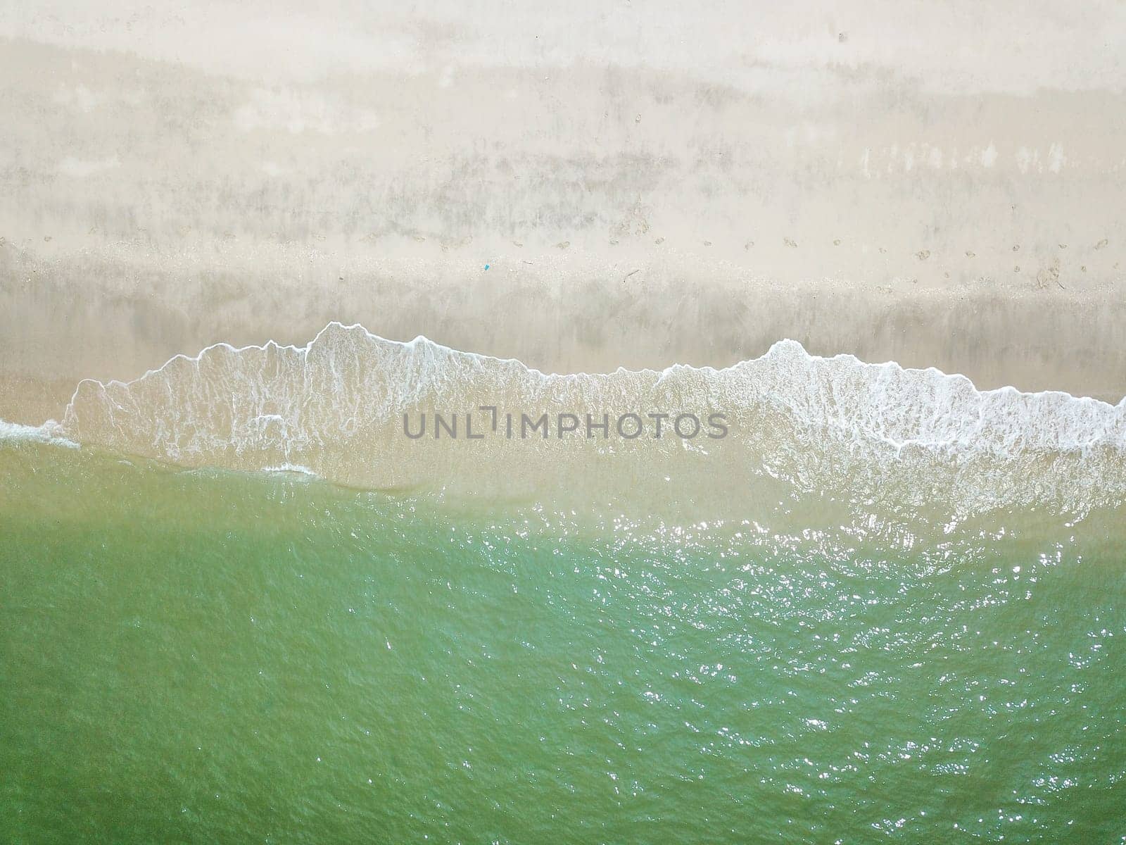 Blue ocean wave on clean sandy beach. Holidays and Travel Concept