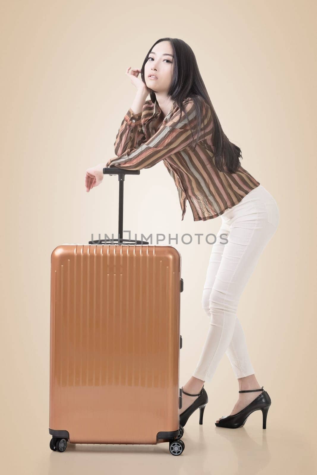 Modern Asian woman stand with a luggage.