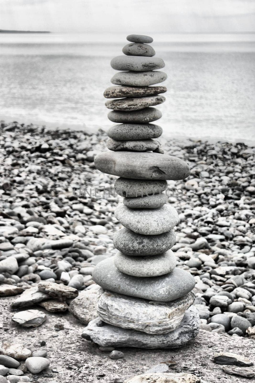 stones balancing on top of each to make a tower on a beach