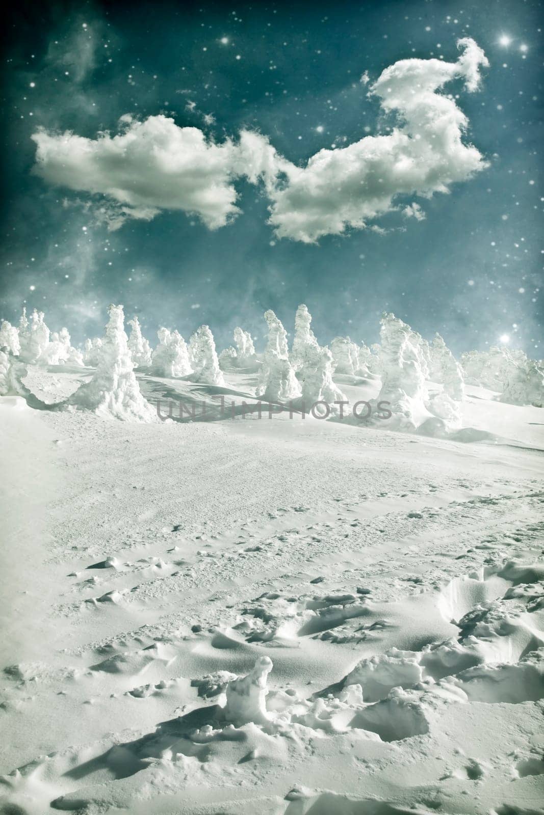 Winter landscape with snow covered hill and cloudy blue sky