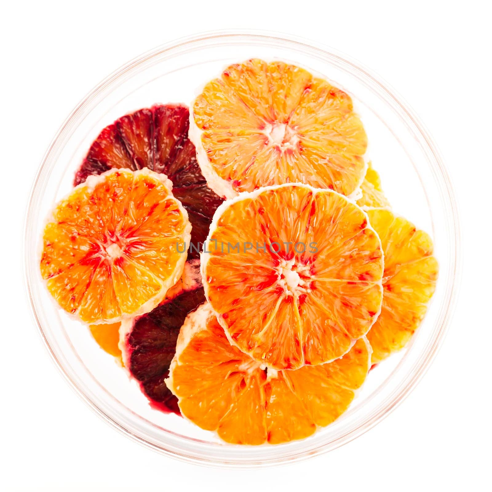 Orange and blood orange slices in glass bowl isolated on white