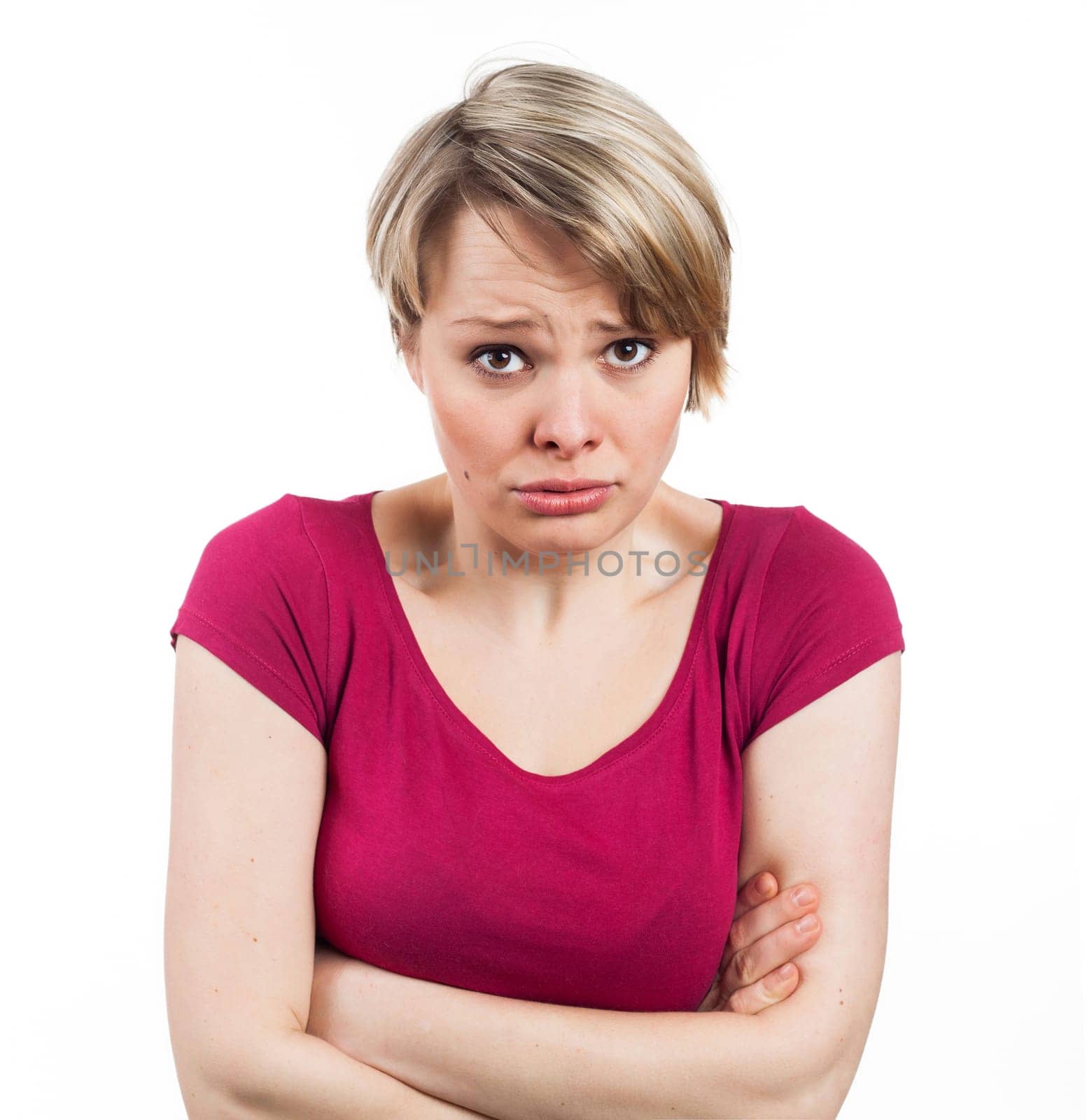 young woman appearing to be in an uncomfortable attitude, isolated on white.