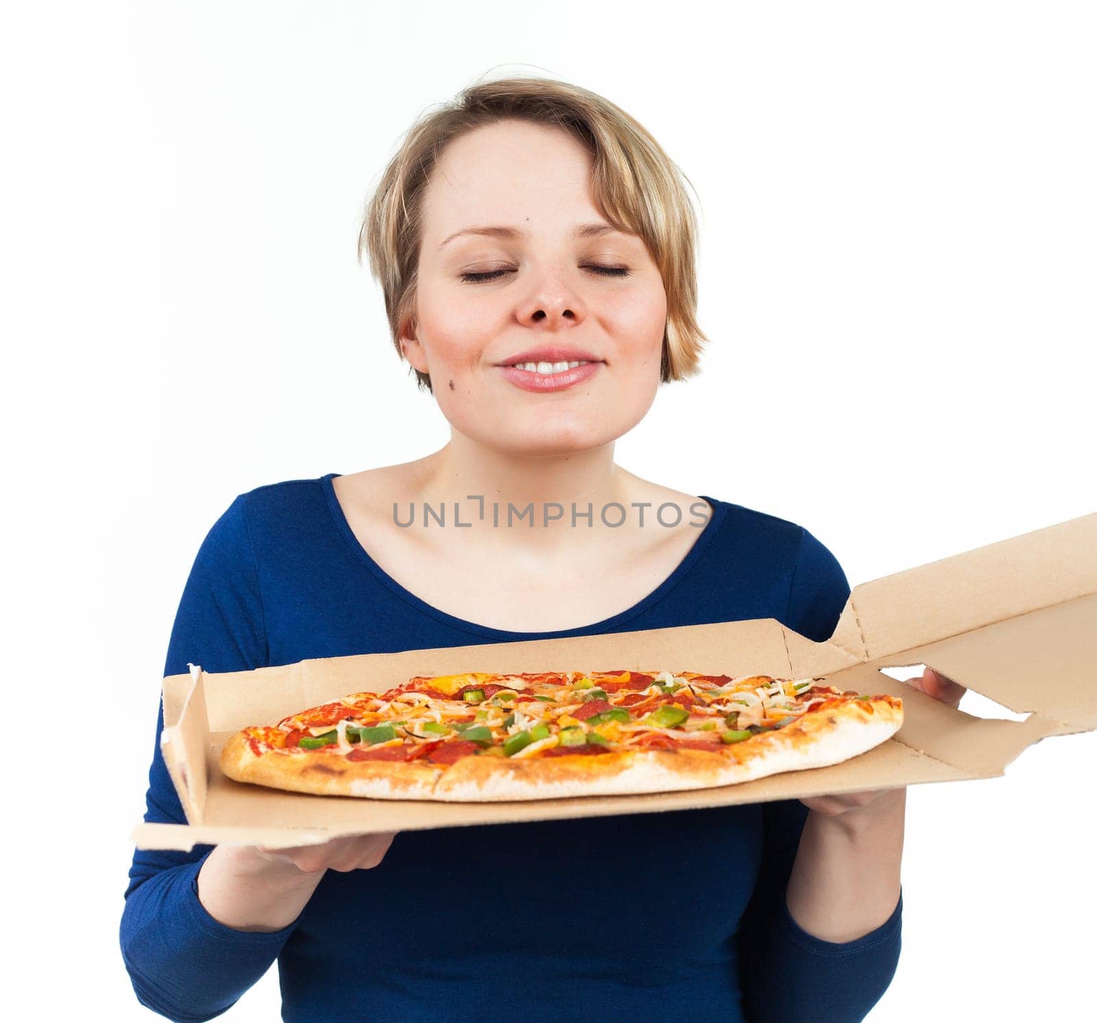 Young woman smelling a pizza from fast food and looking very attracted, isolated on white