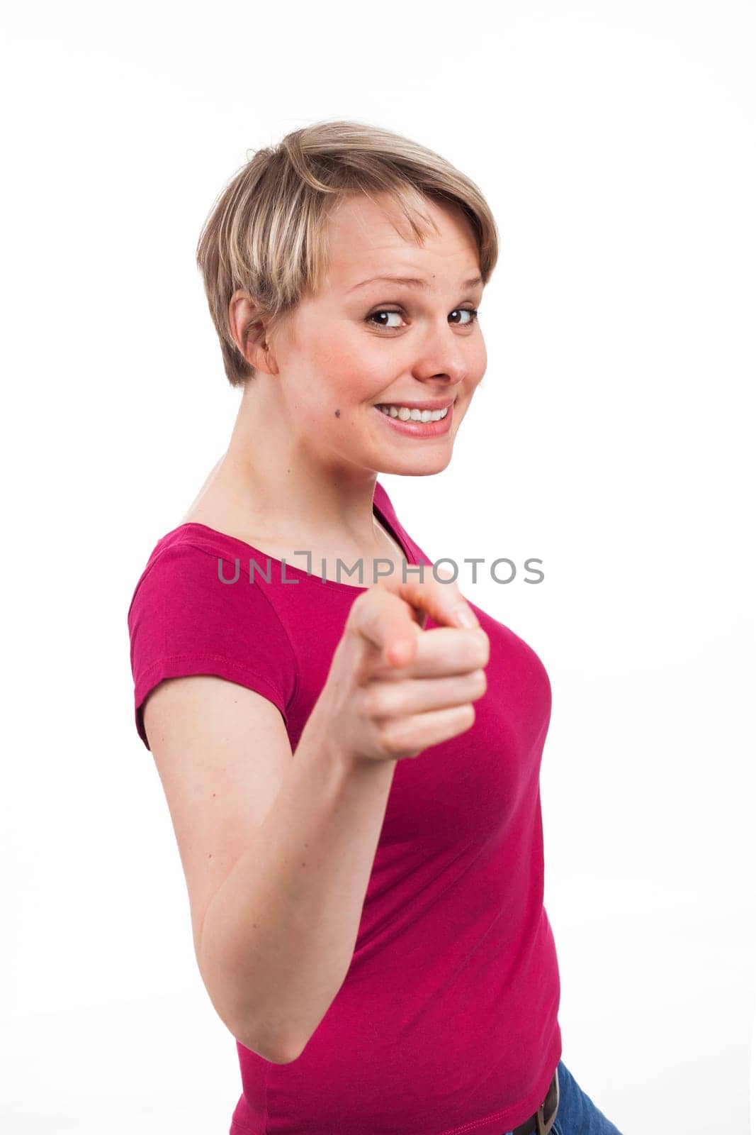 Portrait of a nice woman pointing someone in front of her, isolated on white