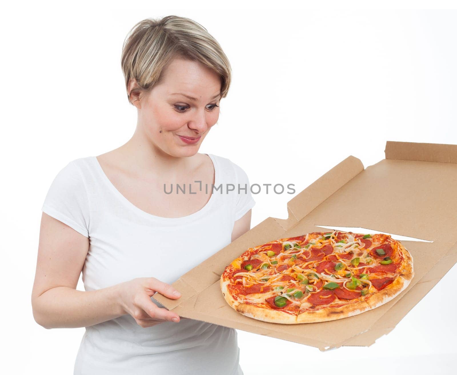 Young woman looking at a pizza with appetite, isolated on white