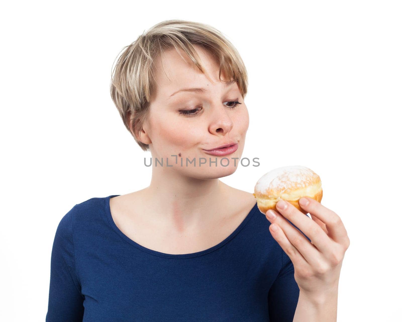 Funny young woman about eating a donut, isolated on white