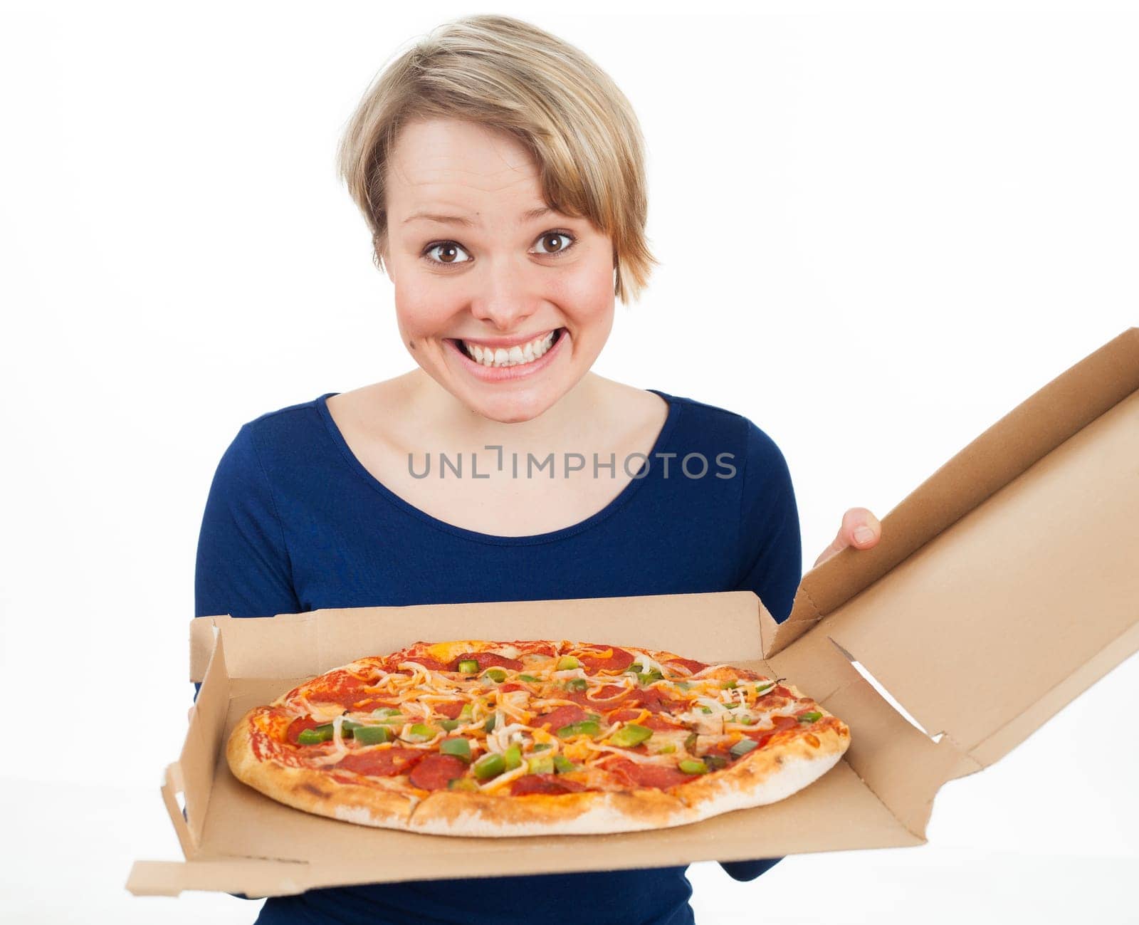 Young woman holding a pizza and looking very happy, isolated on white