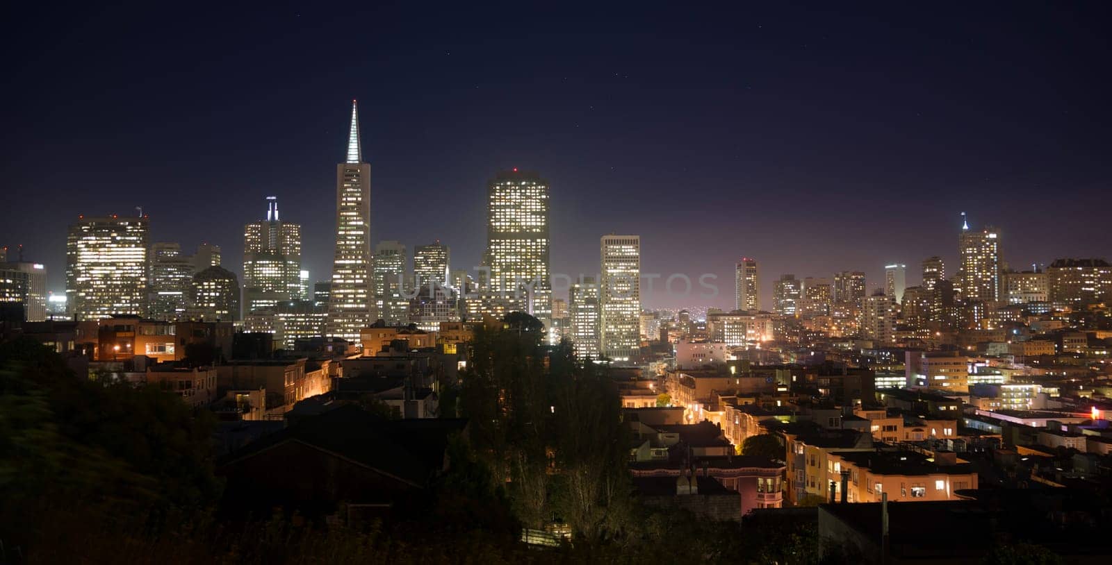Night falls over the recognizable downtown skyline of San Francisco