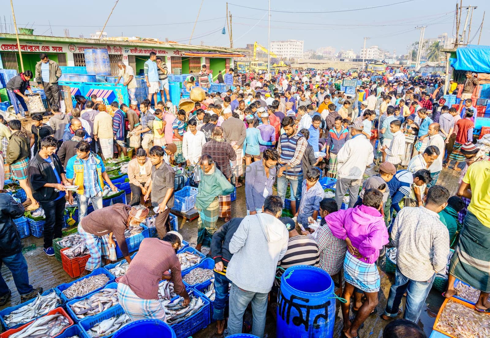 Chittagong, Bangladesh, December 23, 2017: Vendors sorting fish at the crowded market near Karnaphuli River in Chittagong