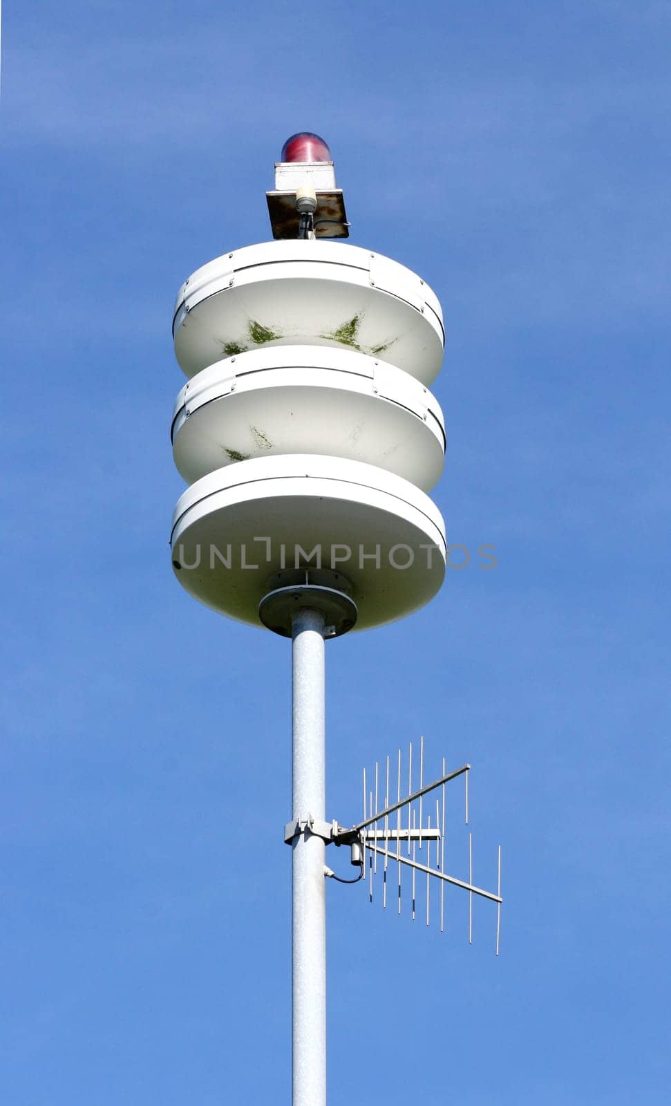 A street lamp, blue sky in the background.