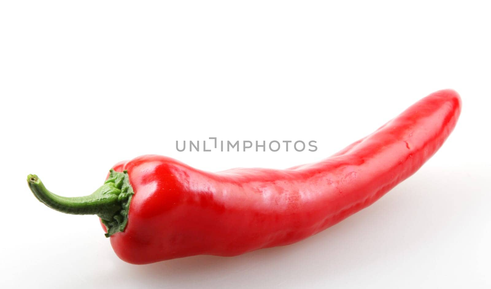Close-Up Of Red Chili Pepper Against White Background