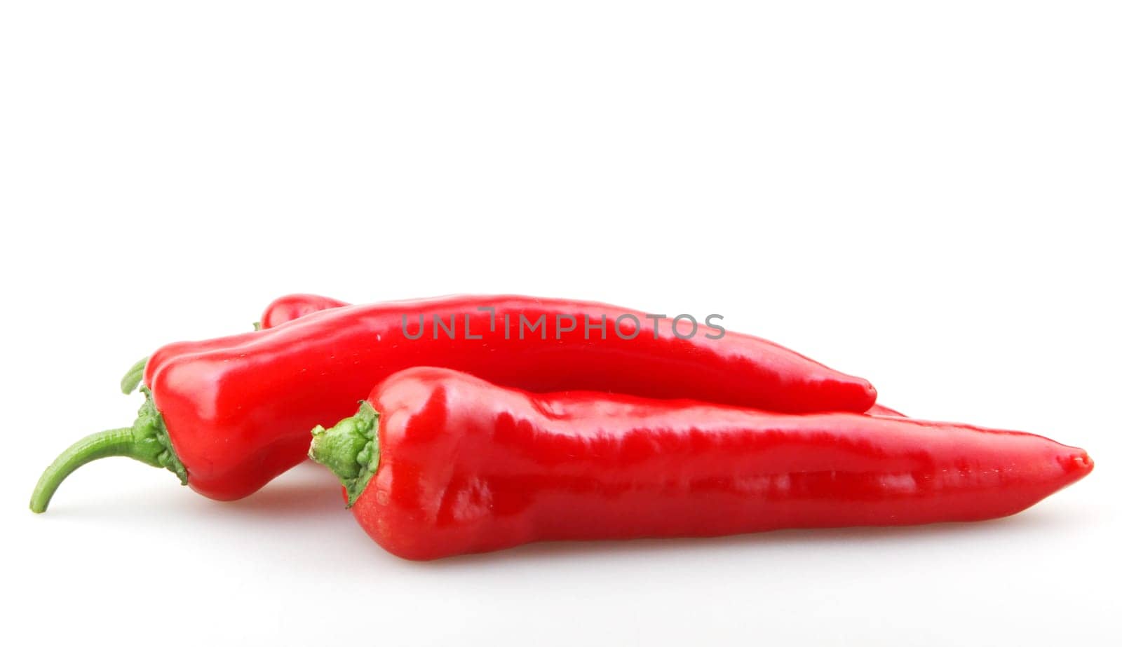 Close-Up Of Red Chili Pepper Against White Background