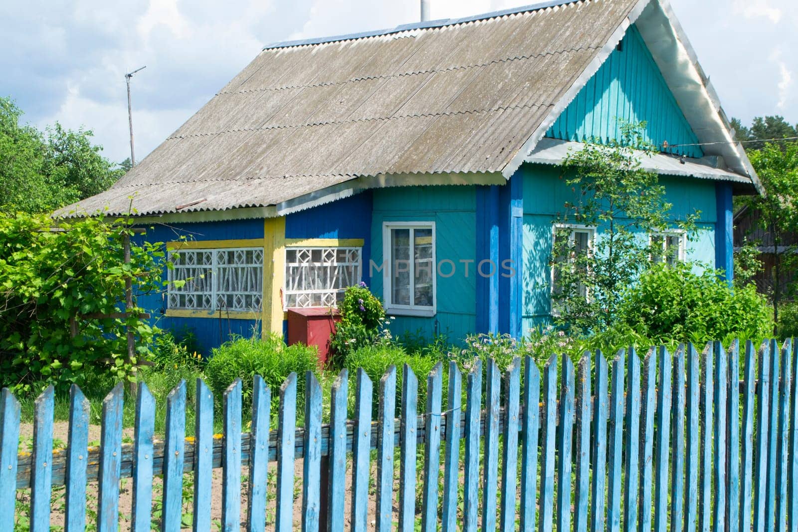 A traditional folk wooden rural house in Belarus with colorful ornamented