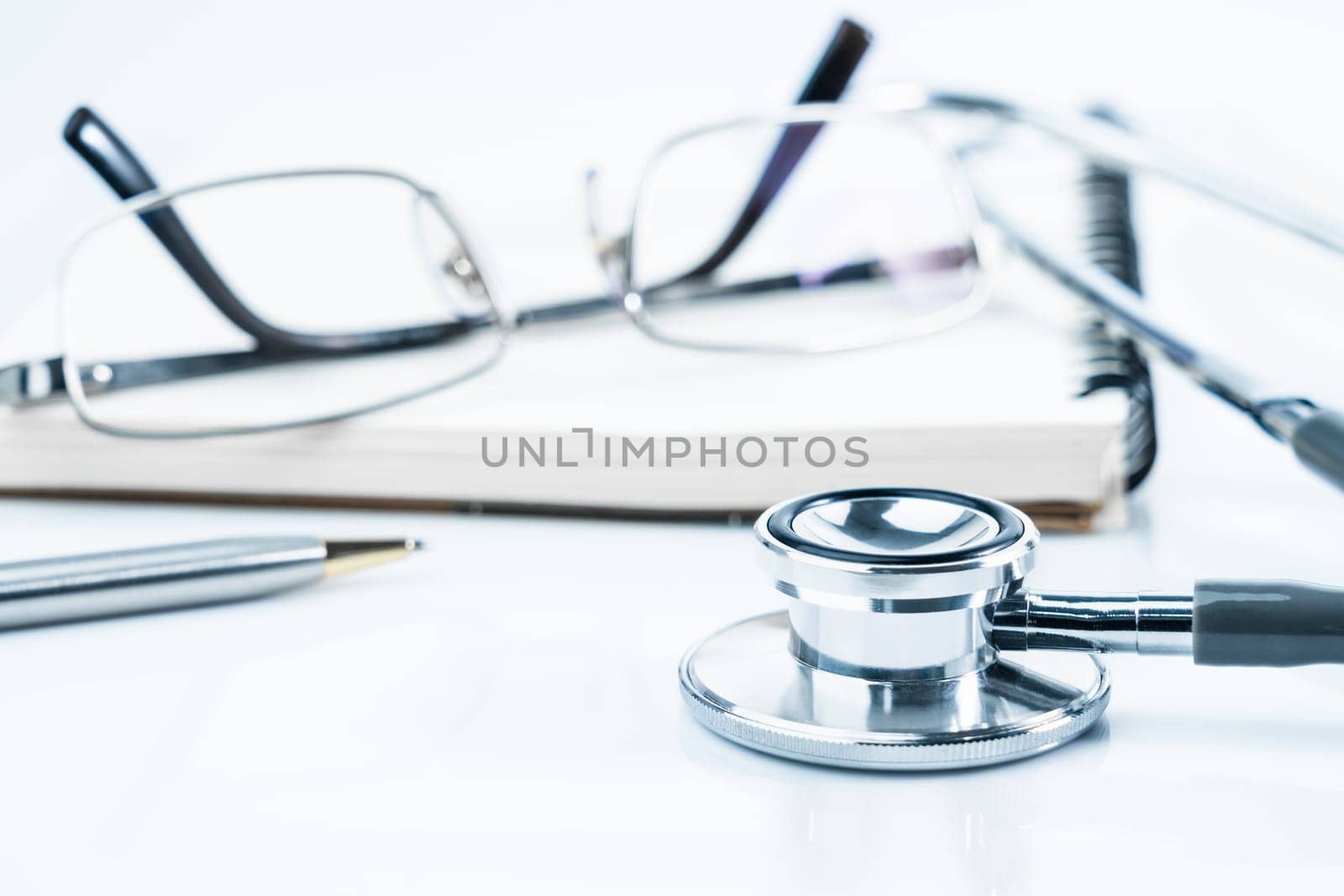 Close up Medical stethoscope with blank notepad as medical concept