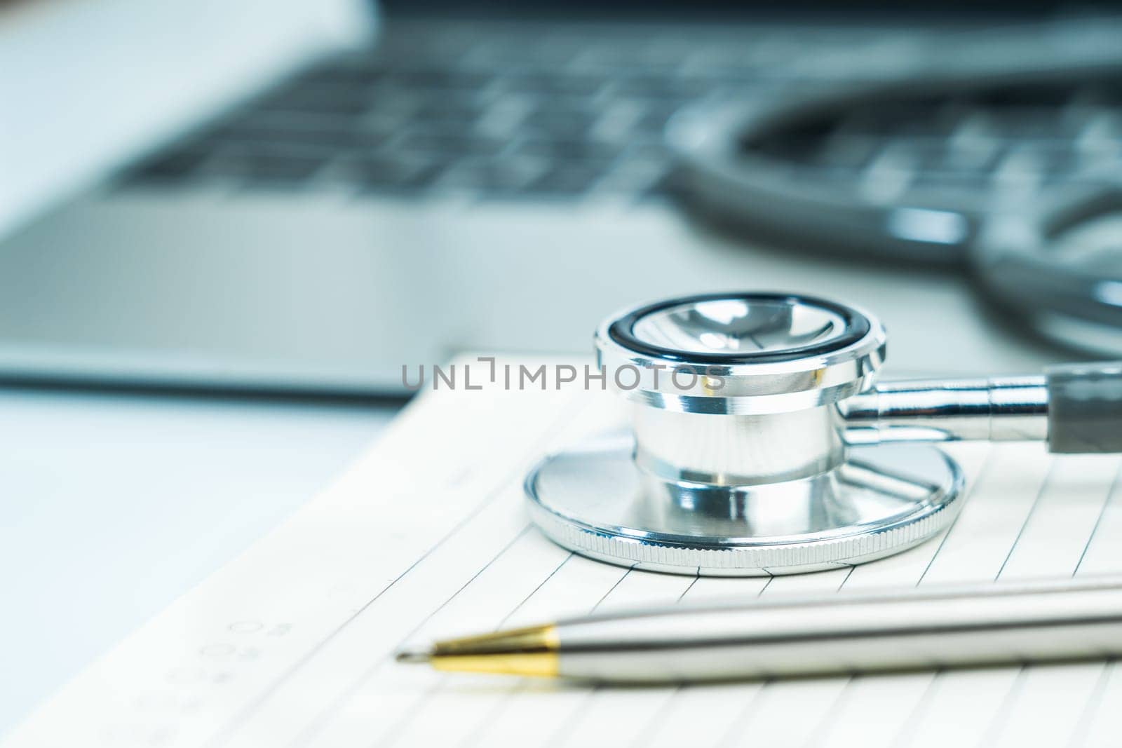 Medical stethoscope for doctor checkup on notepad as medical concept